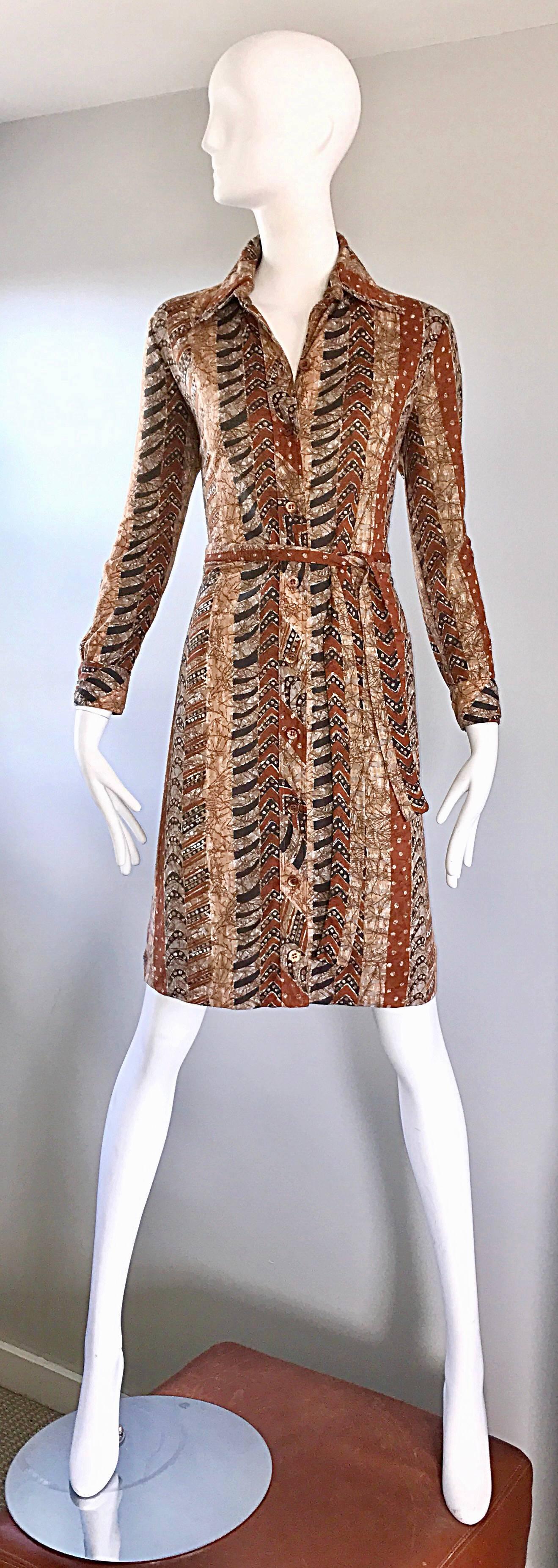 Chic vintage  1970s BONWIT TELLER batik printed cotton shirt dress! Features warm tones of brown, terra-cotta, tan and ivory. Buttons up the entire front, and at each sleeve cuff. Detachable matching tie belt gives a nice shape. Super soft cotton.