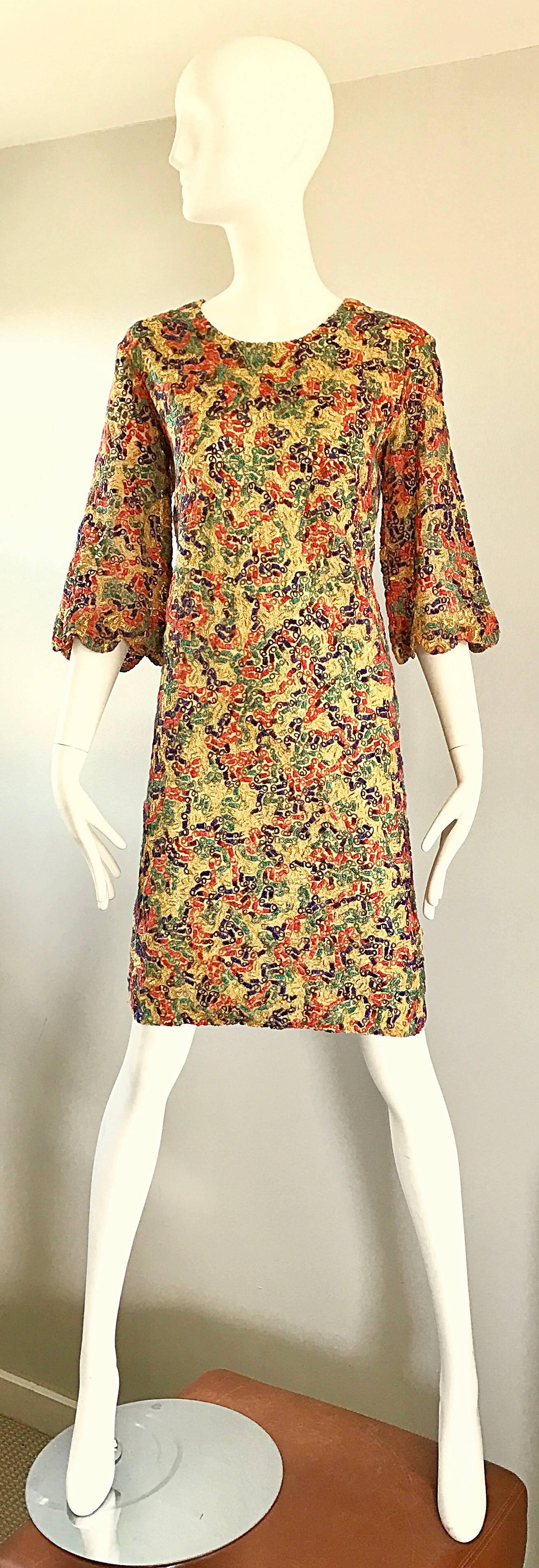 Amazing 1960s colorful shift dress w/ bell sleeves! Features threading throughout in vibrant hues of green, red, yellow, and blue throughout, with a marigold base. Scalloped 3/4 bell sleeves. Amazing quality, with lots of attention to detail. Zips