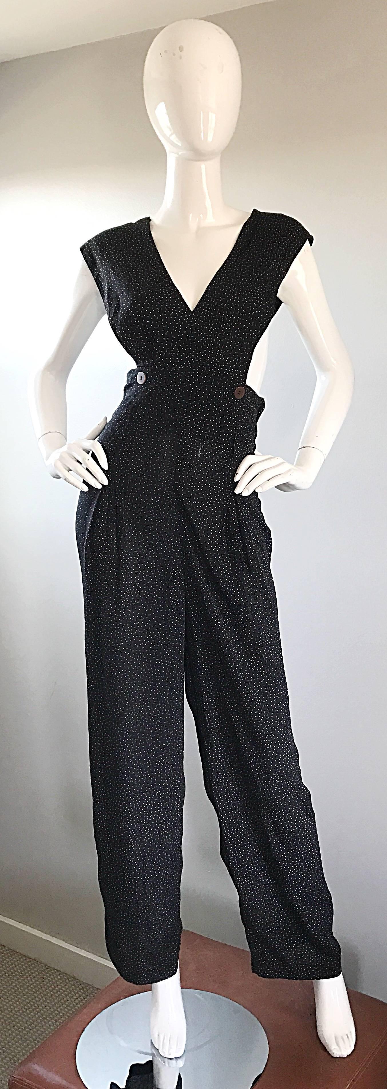 Amazing vintage 90s SHELLI SEGAL black, brown and white mini polka dot rayon jumpsuit! Features a brown button at each side of the waist. Sleeveless style, with open sides. Hidden zipper up the side with hook-and-eye closure. Looks great alone, or