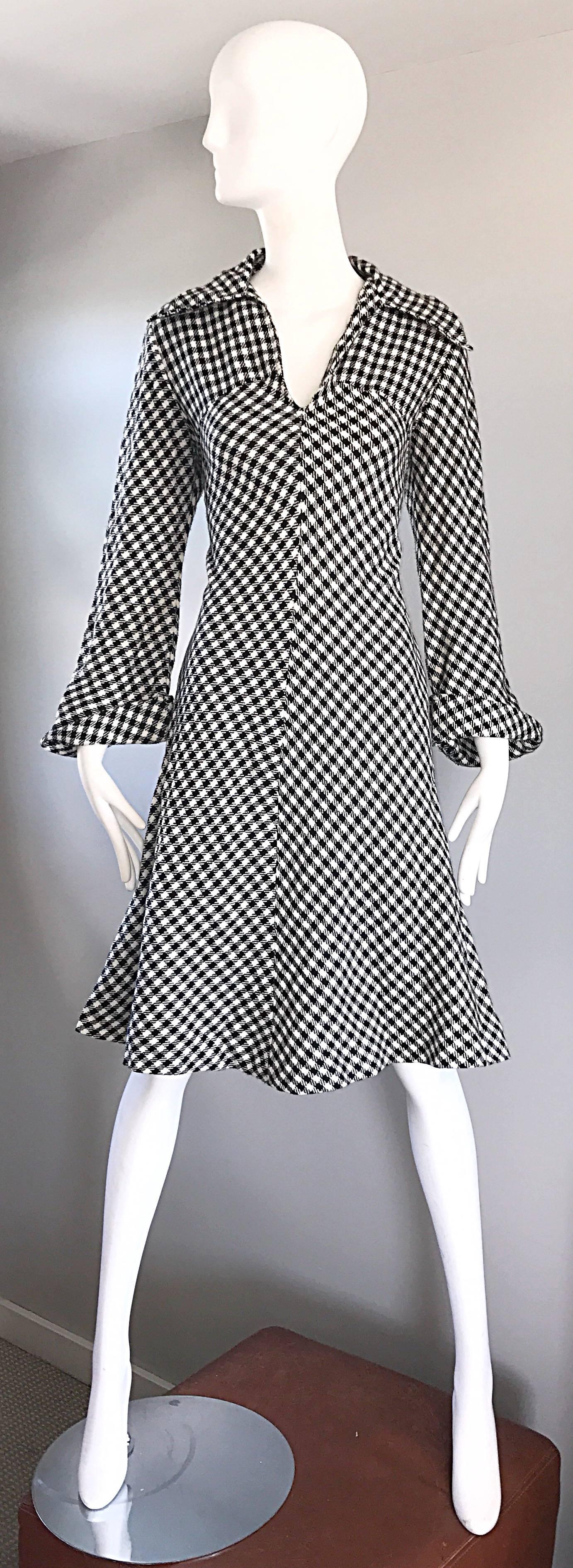 Chic late 1960s black and white large houndstooth long sleeve A-line dress! Features a fitted bodice with a full skirt. Oversized collar, and bell sleeves that cuff at the hem. Features pockets at each side of the waist. Simply slips over the head.