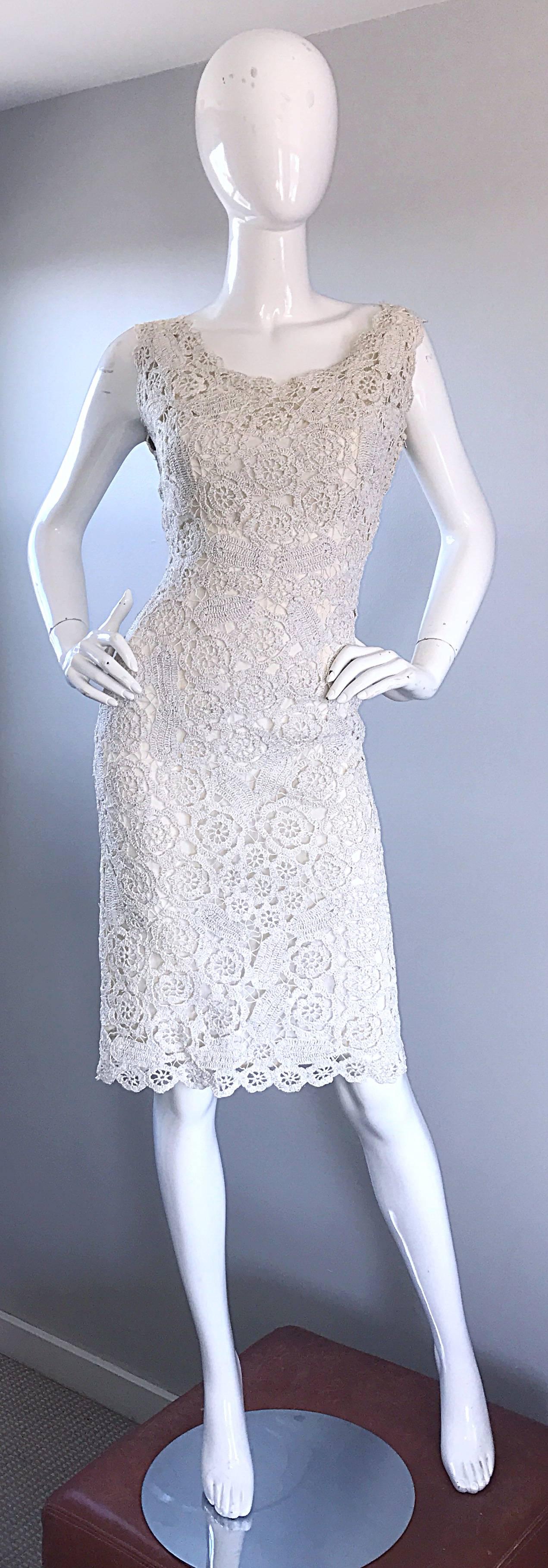 Beautiful 1950s demi couture white and silver raffia wiggle dress! Features white raffia with silver metallic threading throughout. Fabulous bombshell fit looks amazing on! Scalloped edges on the sleeves and skirt. Fully lined. Full metal zipper up