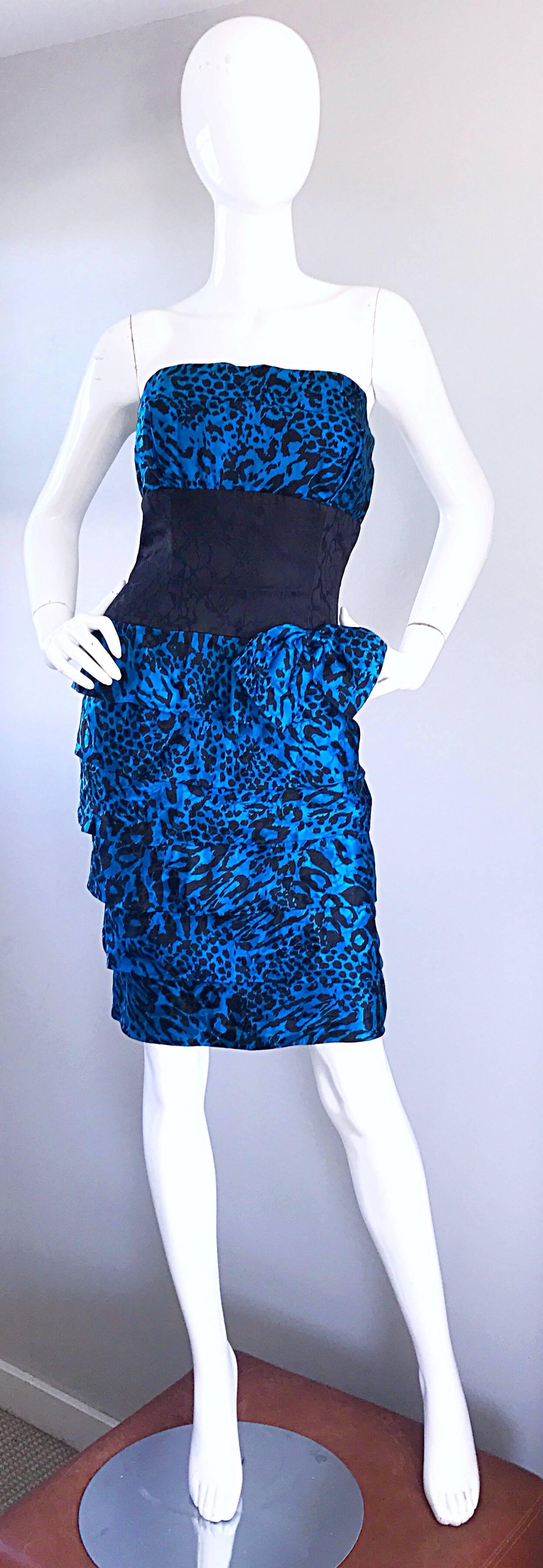 Fabulous 1980s blue and black cheetah print strapless silk dress! Features an allover animal print. Interior boned bodice holds everything in place. Fitted bodice, with a tiered ruffle skirt. Attached side bow at left waist. Hidden zipper up the