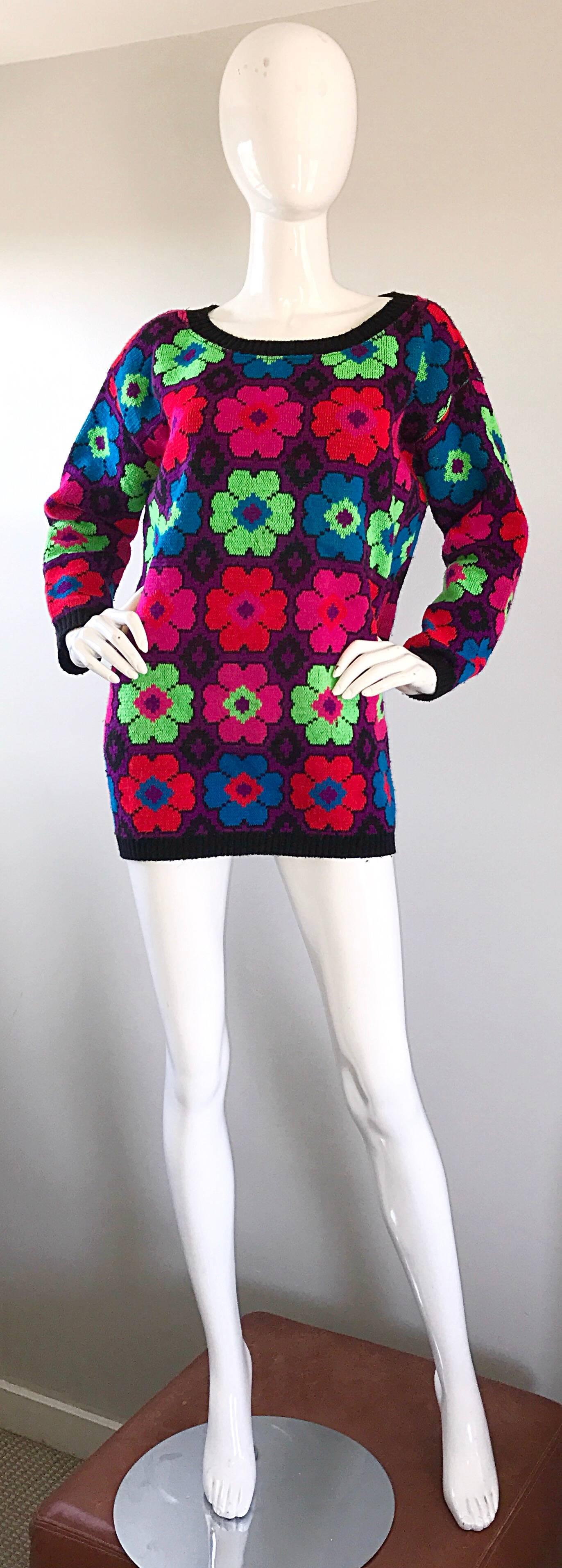 Amazing and rare vintage early 80s BETSEY JOHNSON PUNK LABEL bright sweater! Features intarsia woven neon flowers in vibrant hues of hot pink, neon green, red, purple, blue and black throughout. A fun piece to throw on witha. Pair of jeans or