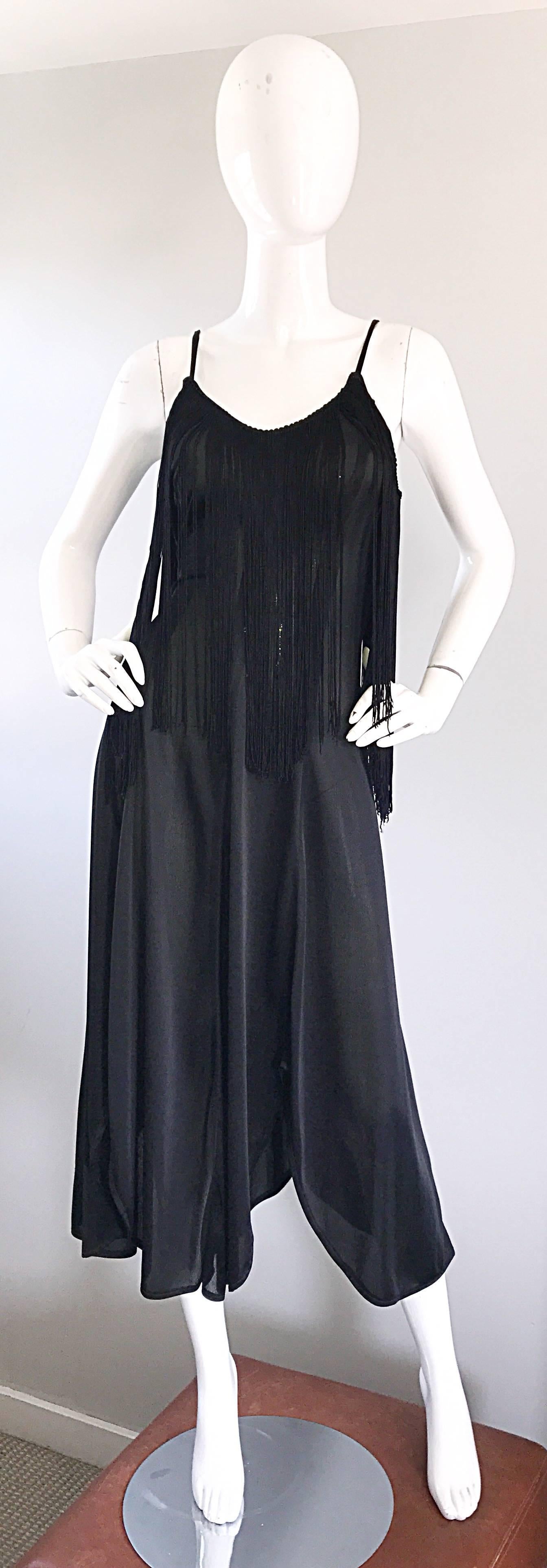 Incredible 70s black disco fringe dress! Features a flirty handkerchief hem, with a tailored bodice. Tons of fringe at the bust makes for a great dancing dress! There is definitely an ode to the 1920s / 20s with this amazing gem! Very well made,