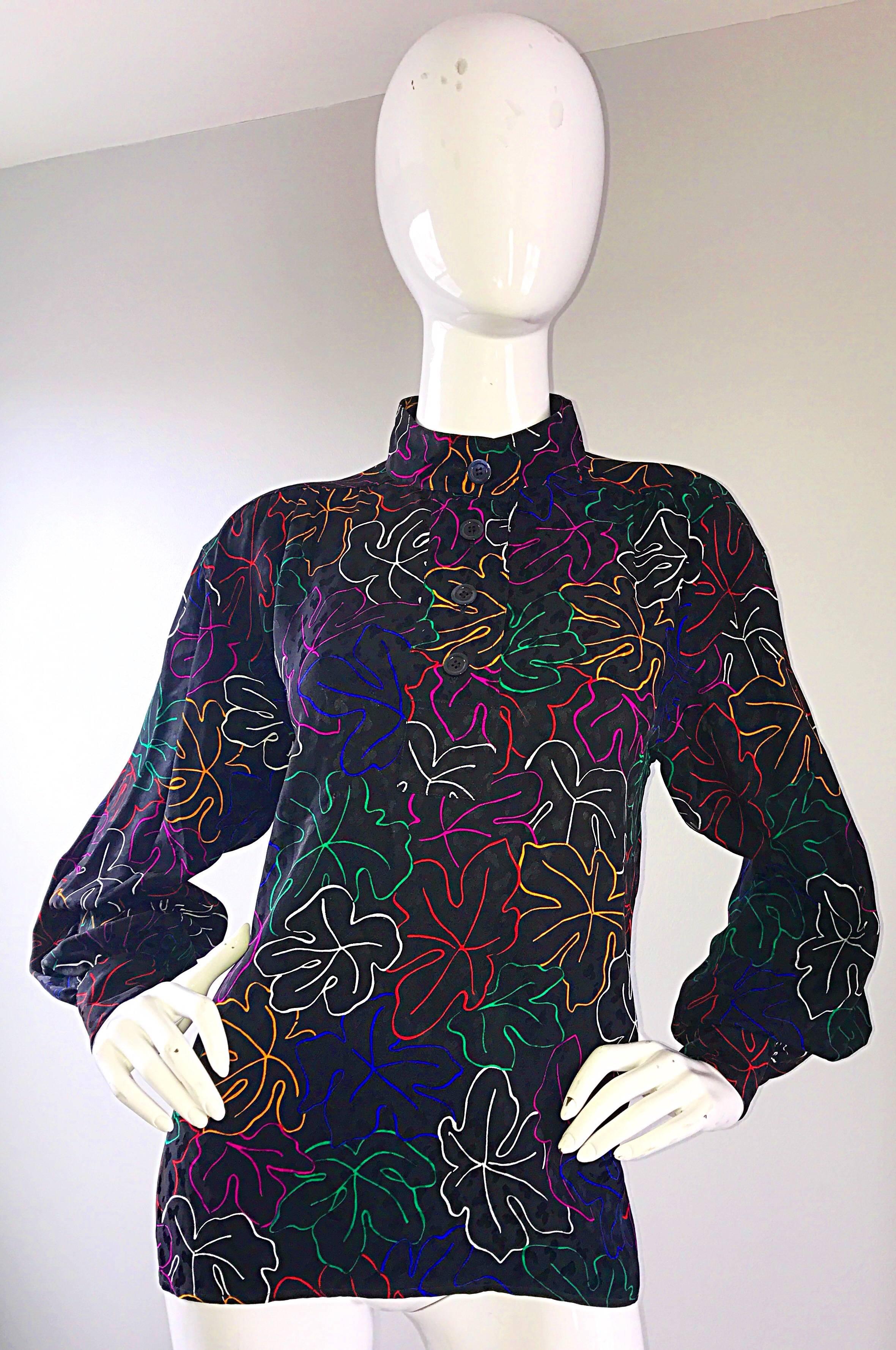 Brilliant late 1970s YVE SAINT LAURENT ' Rive Gauche ' black silk blouse! Features vibrant colored outlined leaf prints throughout in fuchsia, green, blue, yellow red, and white. Four buttons up the top bodice can be closed or left open. Buttons at