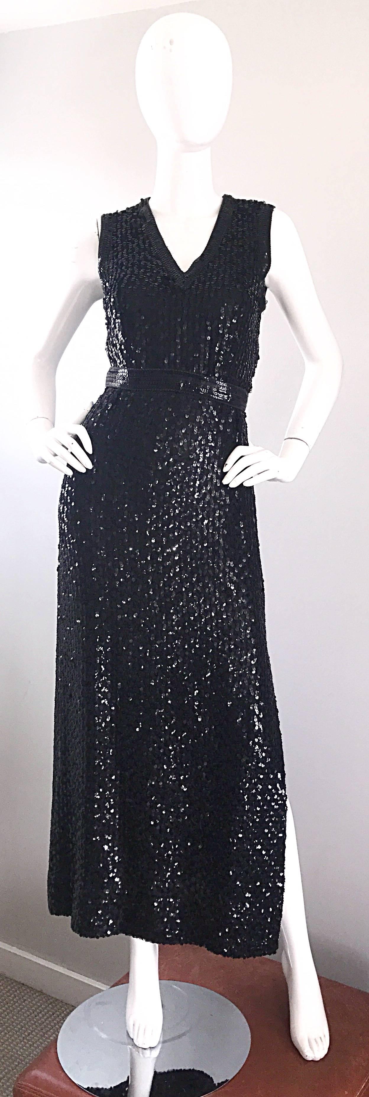 Gorgeous vintage 70s LILLIE RUBIN black silk fully sequined sleeveless gown! Features thousands of hand-sewn sequins throughout the entire dress. Attached belt hooks closed at the back center waist. Slit up the side left leg reveals just the right