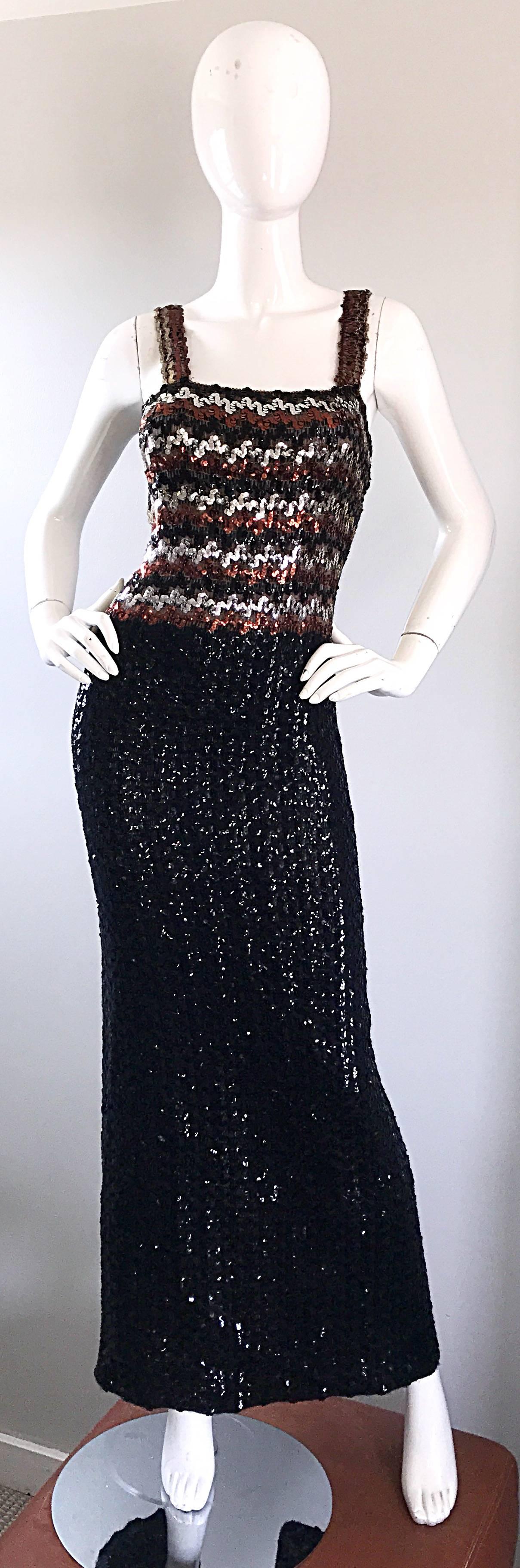 Sexy 1970s fully sequined sleeveless full length knit dress! Features thousands of hand sewn black, brown and silver sequins throughout. Flattering zig-zag pattern on the front and back of the bodice. Slit up the back center reveals just the right