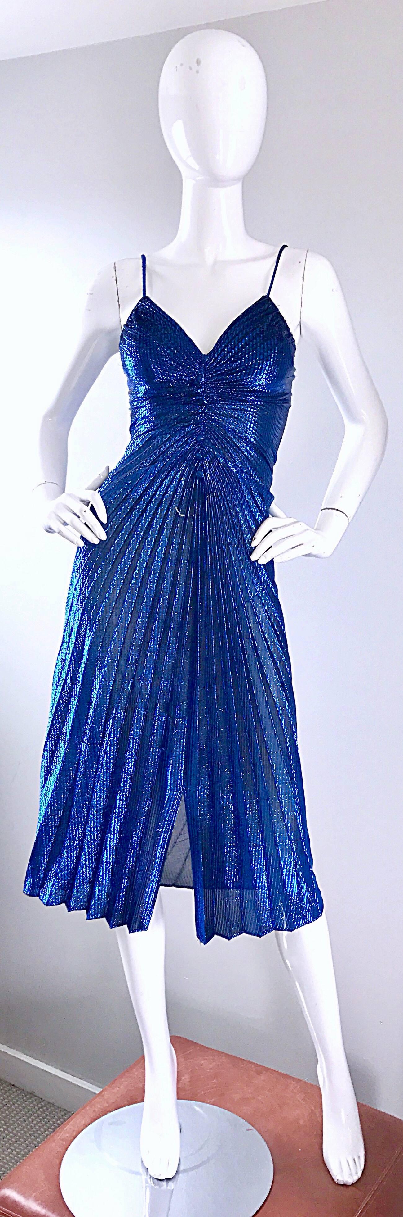 Amazing 1970s SAMIR vibrant blue metallic sexy sleeveless disco dress! Flattering pleating detail throughout. Fitted bodice with mock buttons up the front. Hidden zipper put he back. Looks amazing on, and perfect for any day or evening event. Great