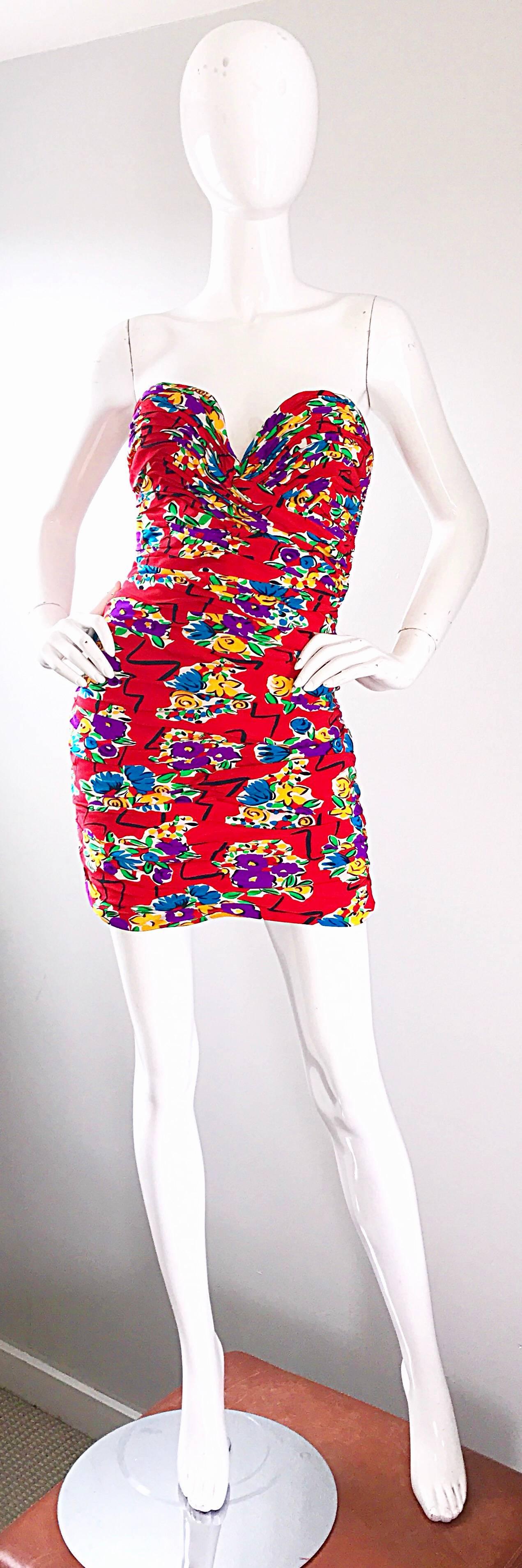 Sensational vintage Mid 80s VICKY TIEL COUTURE red silk strapless mini cocktail dress! Features a vibrant lipstick red background, with purple, blue, yellow and green flowers throughout. Black geometric shapes intertwined between the flowers.