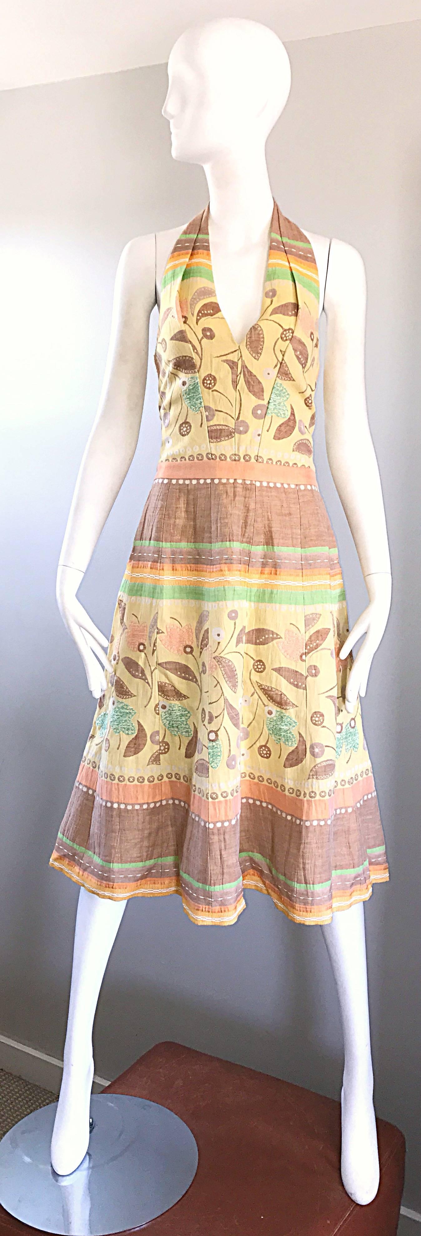 Chic LUCA LUCA halter dress! Soft cotton and linen blend. Embroidered flowers and leaves printed throughout. Beautiful pastel colors in yellow, green, orange and brown throughout. Fully lined in silk. Hidden zipper up the back with hook-and-eye