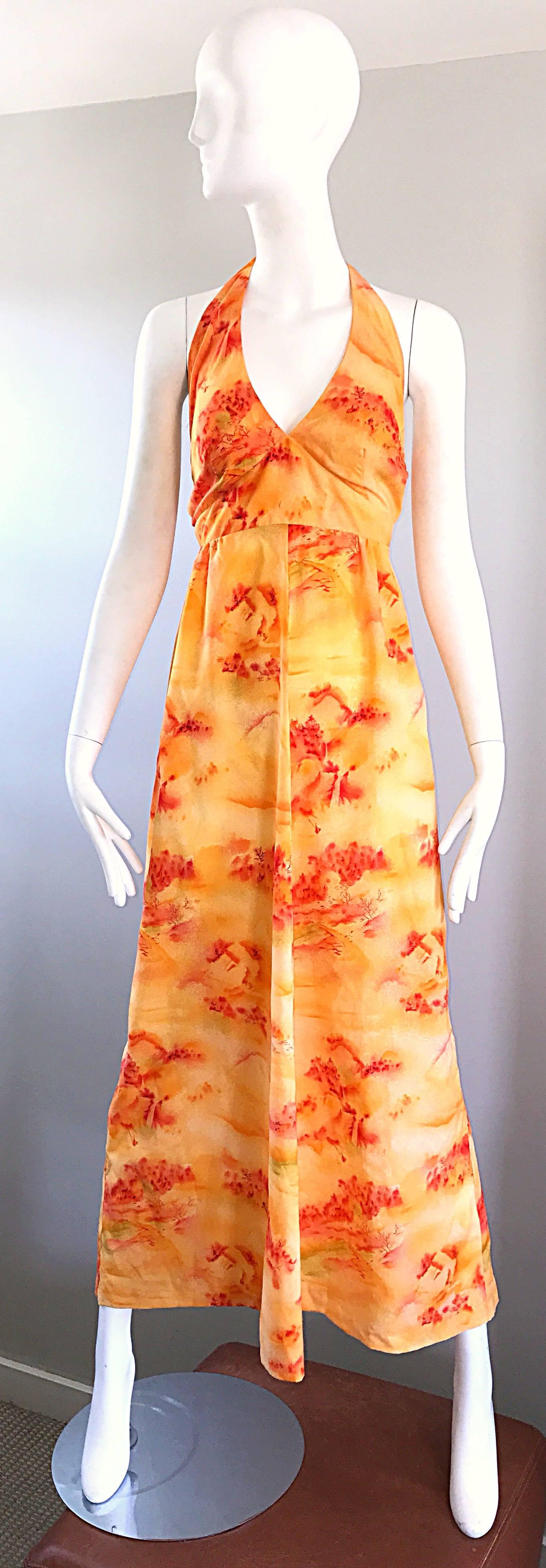 Incredible 1970s Asian themed novelty boho maxi dress! Features a vibrant bright orange, with prints in a brighter orange and red orange throughout. Ties at back top neck with zipper up the skirt. Great with sandals, flats or wedges for day and