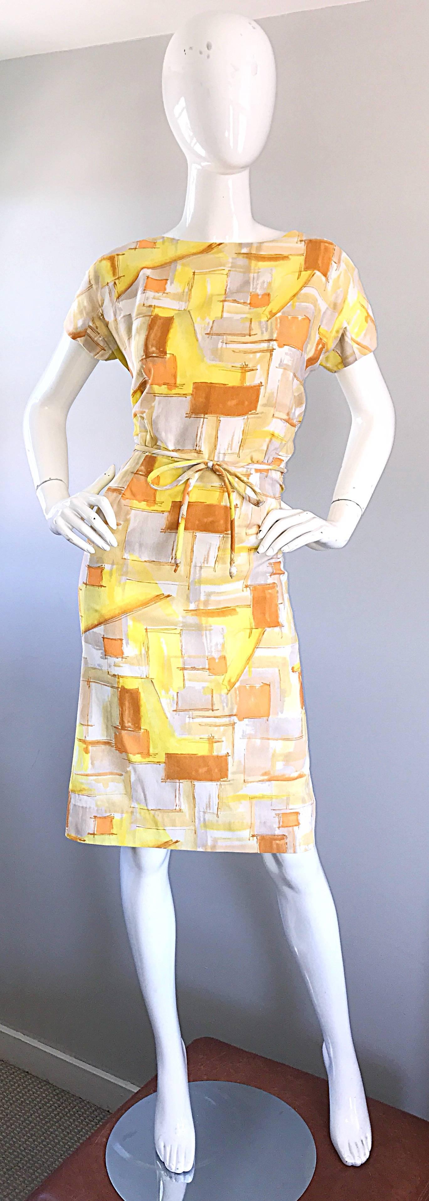 Chic early 1960s yellow, orange, burnt orange and white geometric abstract belted short sleeve day dress! Flattering fit, with a detachable belt to form a waistline. Hidden metal zipper up th eback with hook-and-eye closure. Could easily be dressed