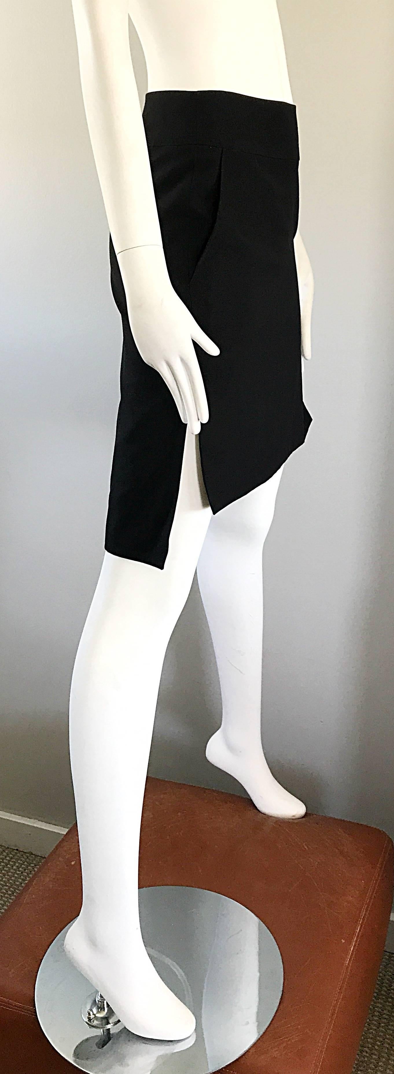 The perfect black early 1990s  vintage hi-low pencil skirt by YVES SAINT LAURENT Rive Gauche YSL ! Features a flattering straight fit, and is shorter in the front, and longer in the back. Pockets at each side of the waist. Hidden zipper up the side