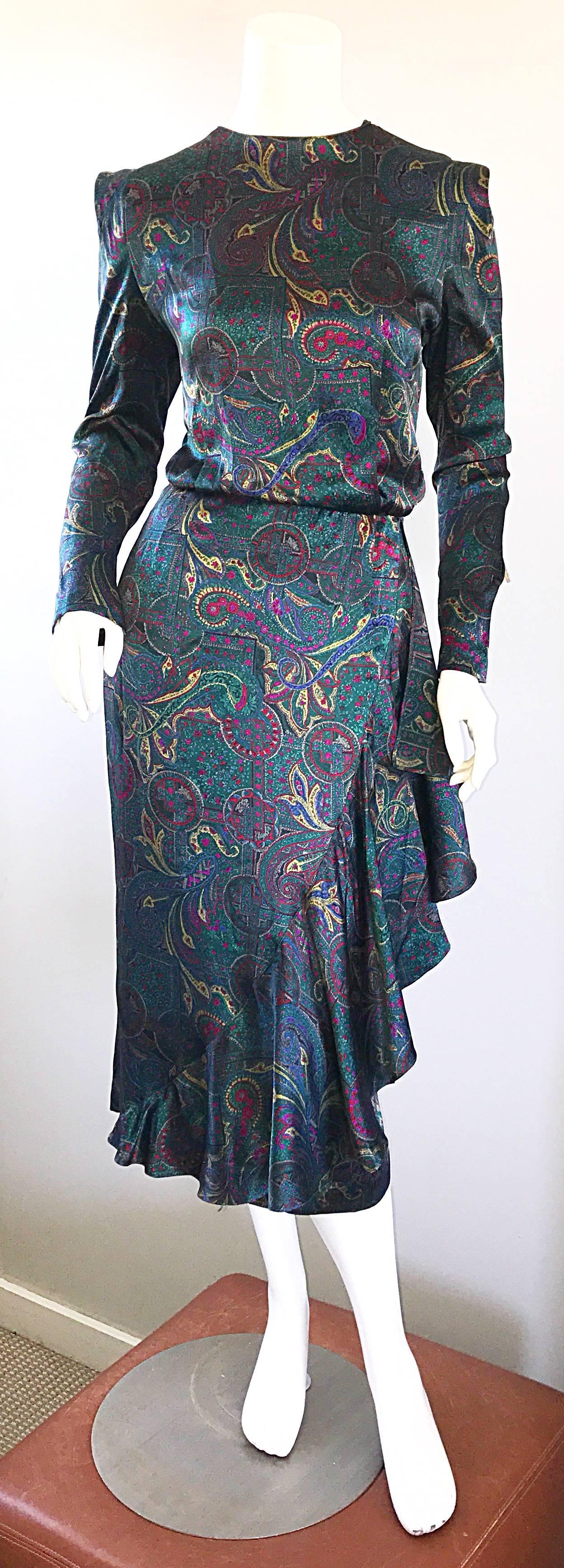 Pretty vintage LOUIS FERAUD emerald jewel tone long sleeve silk dress! Features fantastic paisley prints in emerald green, fuchsia pink, blue, and yellow. Sleek slim bodice with a flamenco style skirt that features an oversided ruffle down the left