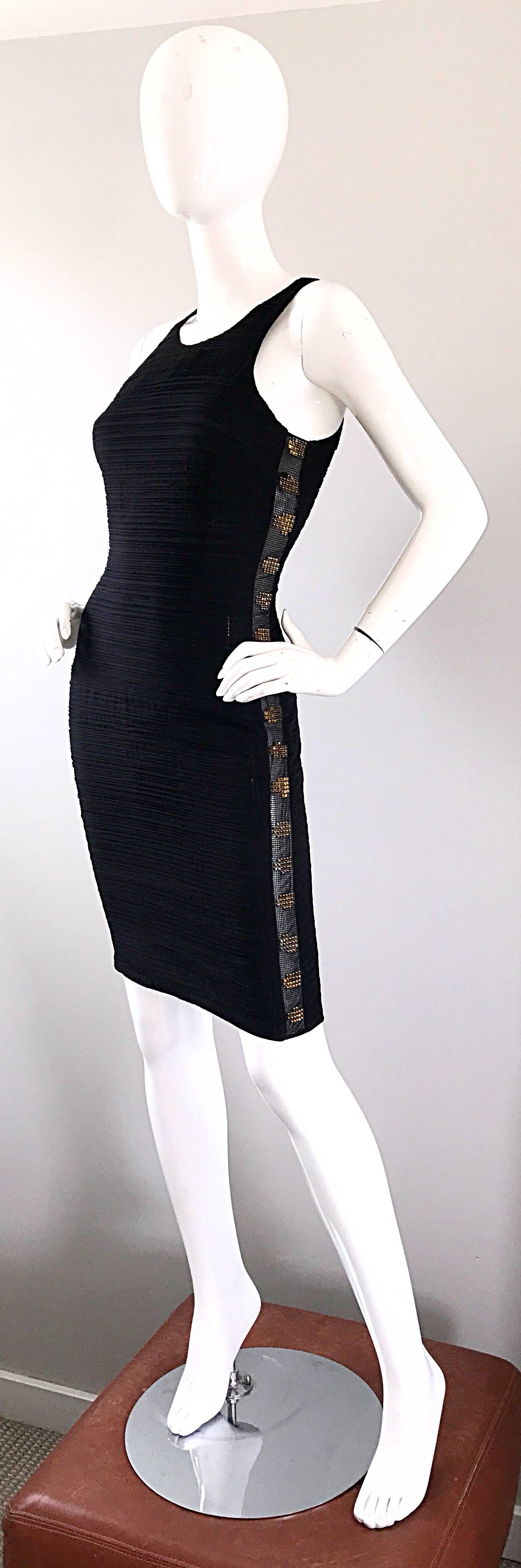 Sexy early 2000s GIANNI VERSACE black silk bodcon dress! Features a cut-out mesh panel encrusted with golden rhinestones down each side of the dress. Flattering cut hugs the body in all the right places. Hidden zipper up the back with hook-and-eye