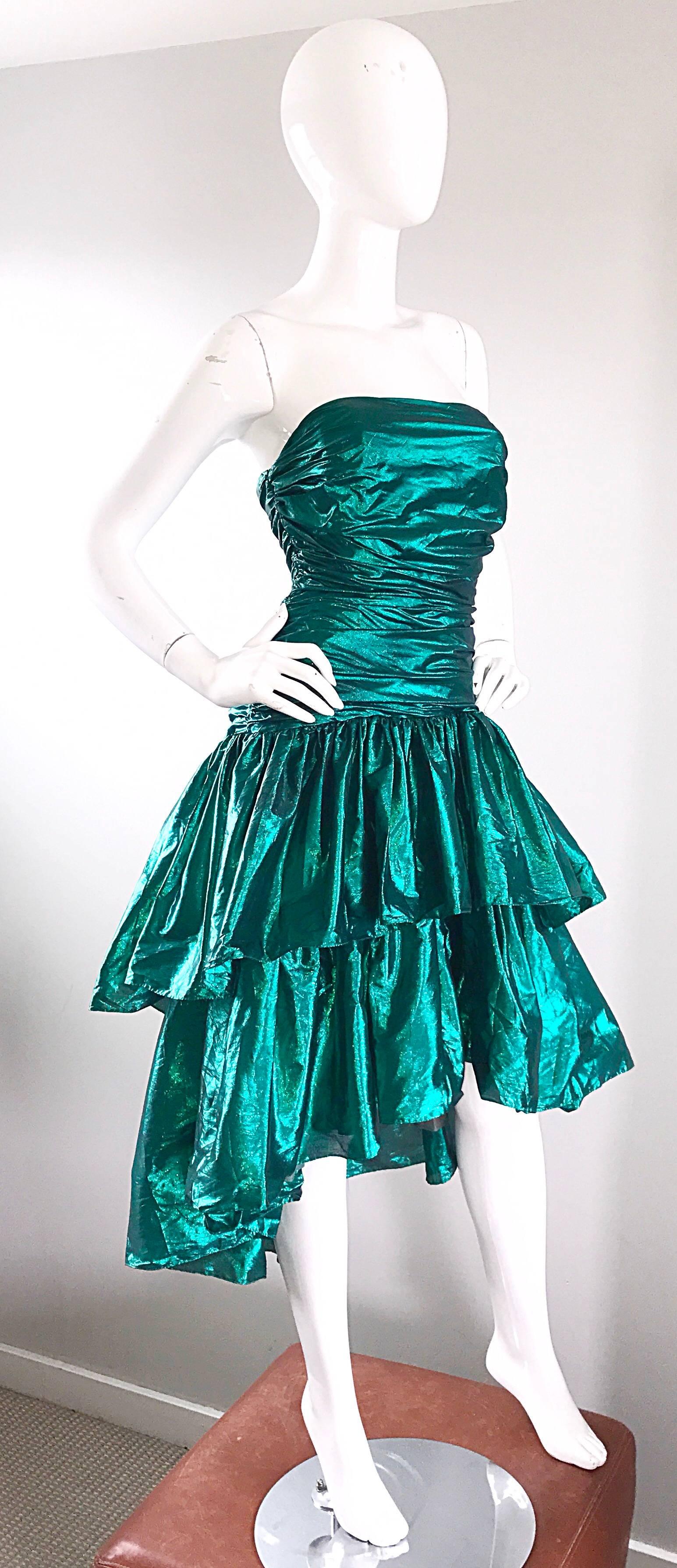 Incredible vintage BETSEY JOHNSON Punk Label 80s metallic green lame strapless hi-lo strapless dress! Flattering ruched bodice with a tiered skirt that is shorter in the front, and longer in the back. Hidden zipper up the back. Great belted or alone