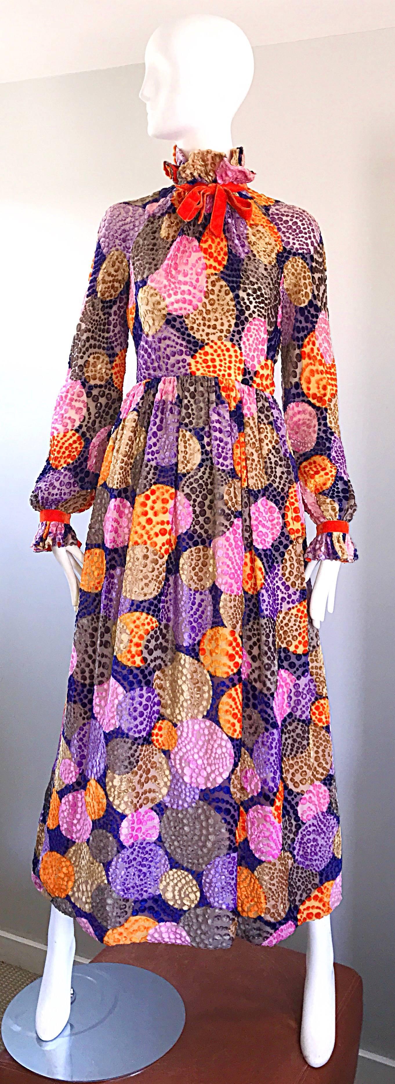 Sensational 1970s GEOFFREY BEENE silk velvet cut-out maxi dress! Features vibrant large polka dots in purple, orange, pink, taupe and brown throughout. Victorian inspired high neck with a pre-tied orange velvet bow. Hidden metal zipper up the back