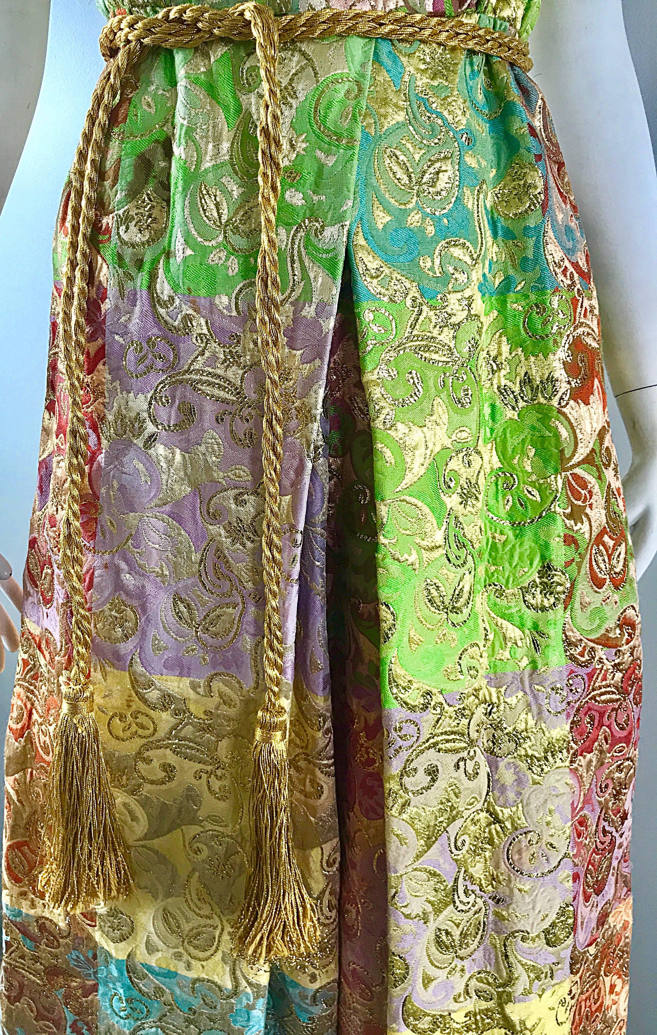 Unbelievable early 1970s JOSEPH MAGNIN silk brocade wide palazzo leg jumpsuit, with original GOLD tassel belt! Features amazing pastel colors of pink, purple, green, blue, yellow, and gold metallic in fabulous paisley prints! Extra wide legs provide