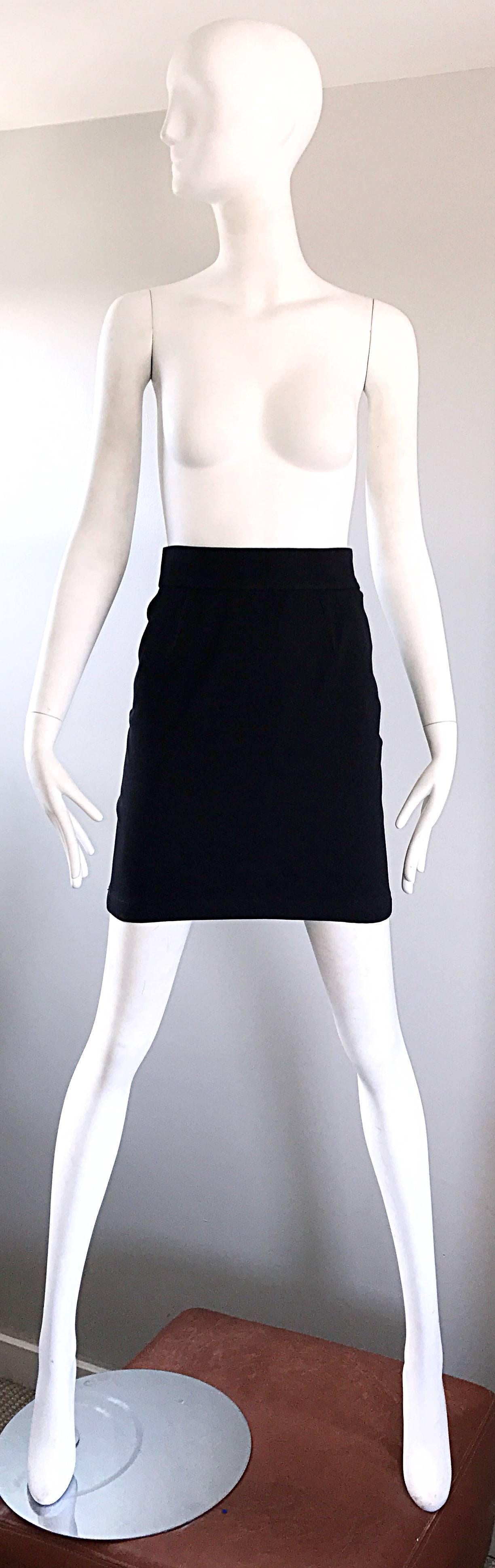 Sexy, yet classic 1990s THIERRY MUGLER black stretch mini skirt! Flattering high waisted style, w/ a classic pencil cut. Features signature angular snap closure at left side of the waist, with a hidden zipper. A classic signature staple piece for