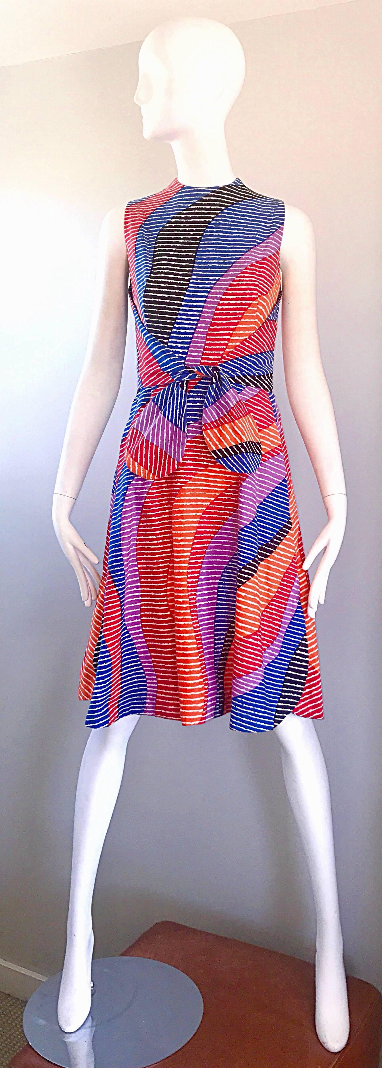 Super chic and rare 1960s GEOFFREY BEENE for SAKS 5th AVENUE brightly colored three dimensional cotton A-Line dress! Features purple, blue, orange, red, and black with white scribbled throughout. Features an attached self tie belt that ties in the