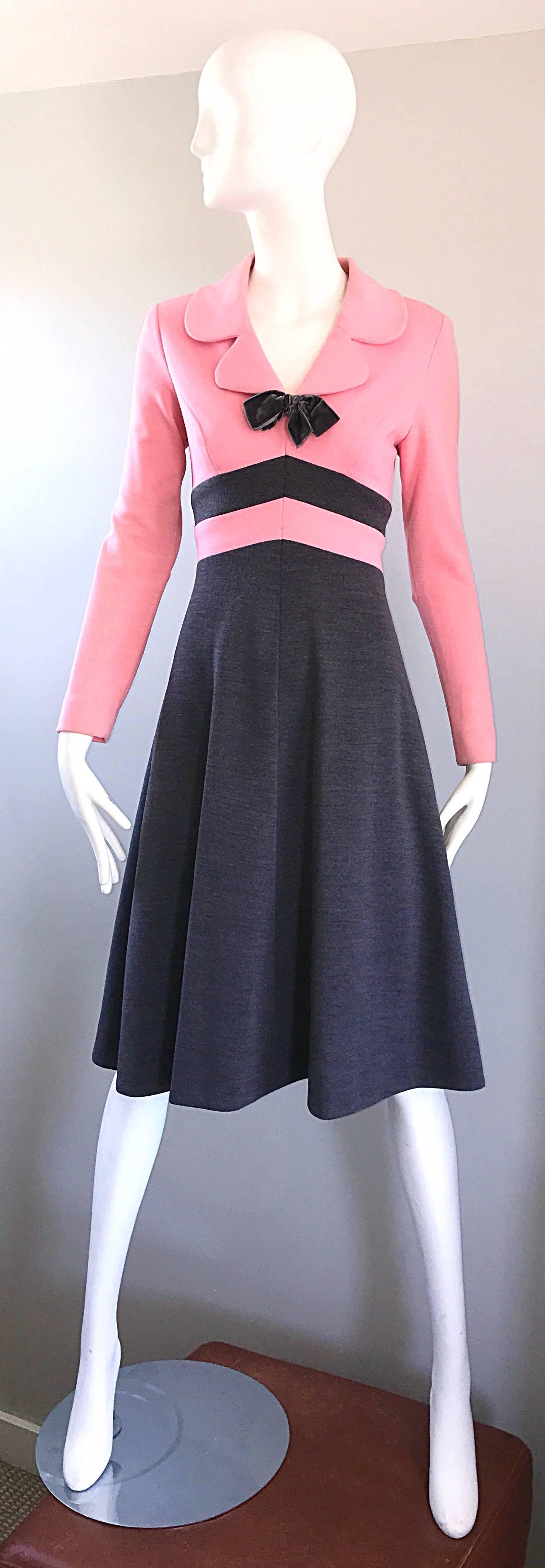 Insanely chic 1960s bubblegum pink and charcoal grey A Line knit dress! Features a chic collar with a grey velvet bow at center neck. Fitted bodice, sleek tailored sleeves, and a flattering full skirt. Hidden metal zipper up the back with