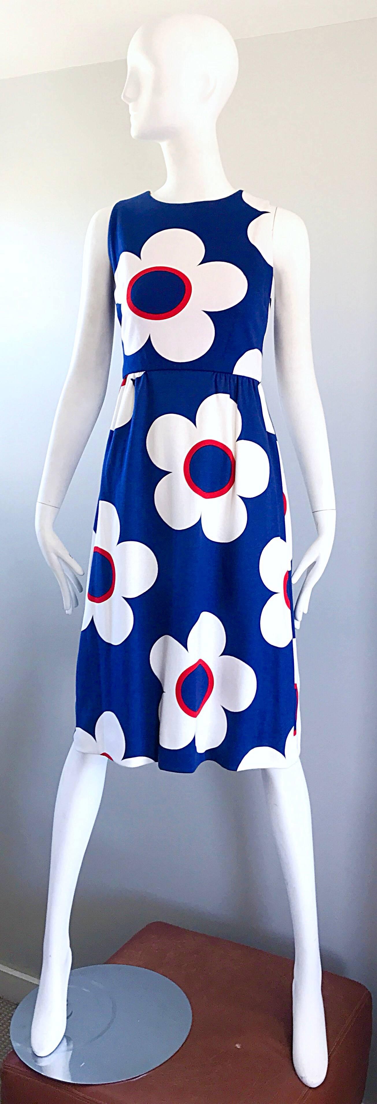 Sensational vintage demi couture navy blue, red and white cotton A-line dress and cropped short sleeve bolero jacket! Features mod flowers throughout both pieces. Full teal zipper up the back with hook-and-eye closure. Fitted bodice with a
