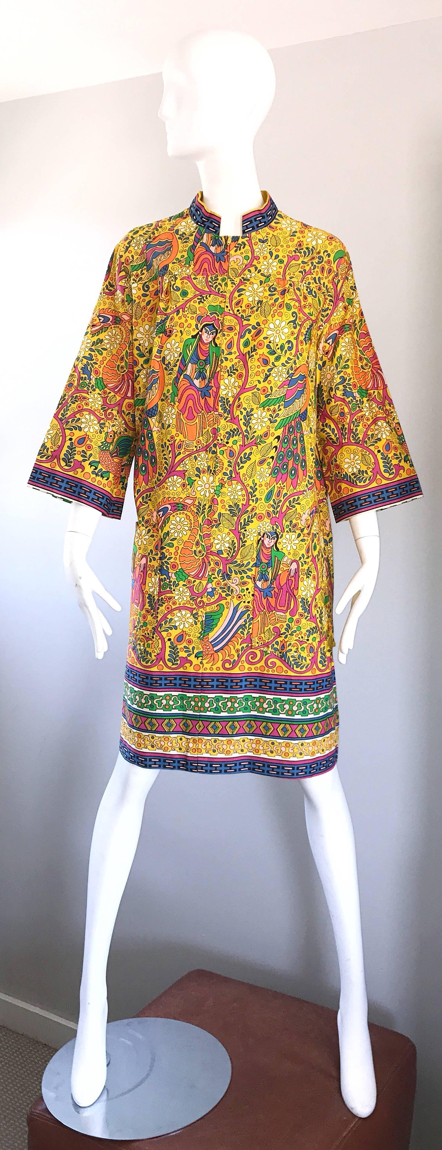 Incredible 1960s Asian Empress Oriental ethnic dragon print cotton tunic dress! Amazing oriental themed prints in vibrant colors of yellow, green, pink, blue, orange, purple, and white throughout. Chic 3/4 length bell sleeves. Hidden zipper up the