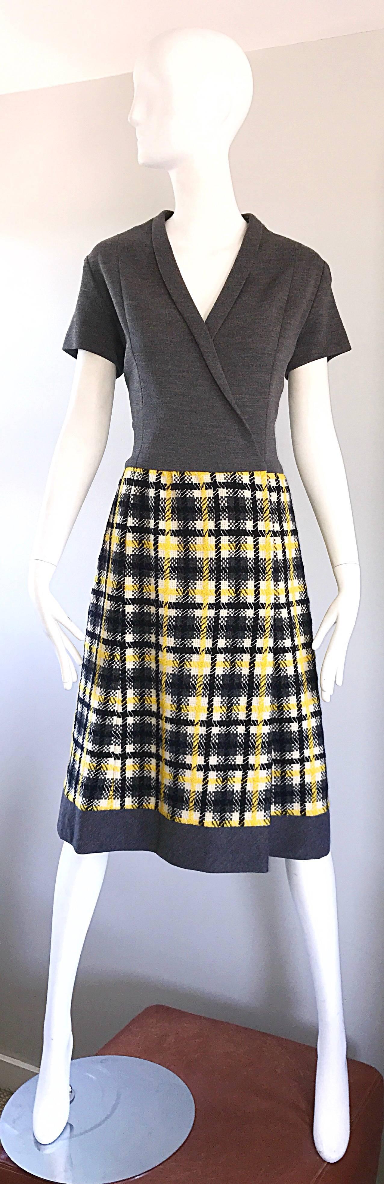 Chic 1960s yellow, grey, black and white plaid wrap style A line dress! Features a fitted charcoal gray bodice, with a wool boucle bell shaped skirt in a tartan plaid. Interior snaps and hook-and-eyes shut at side interior, and at bust. Demi couture