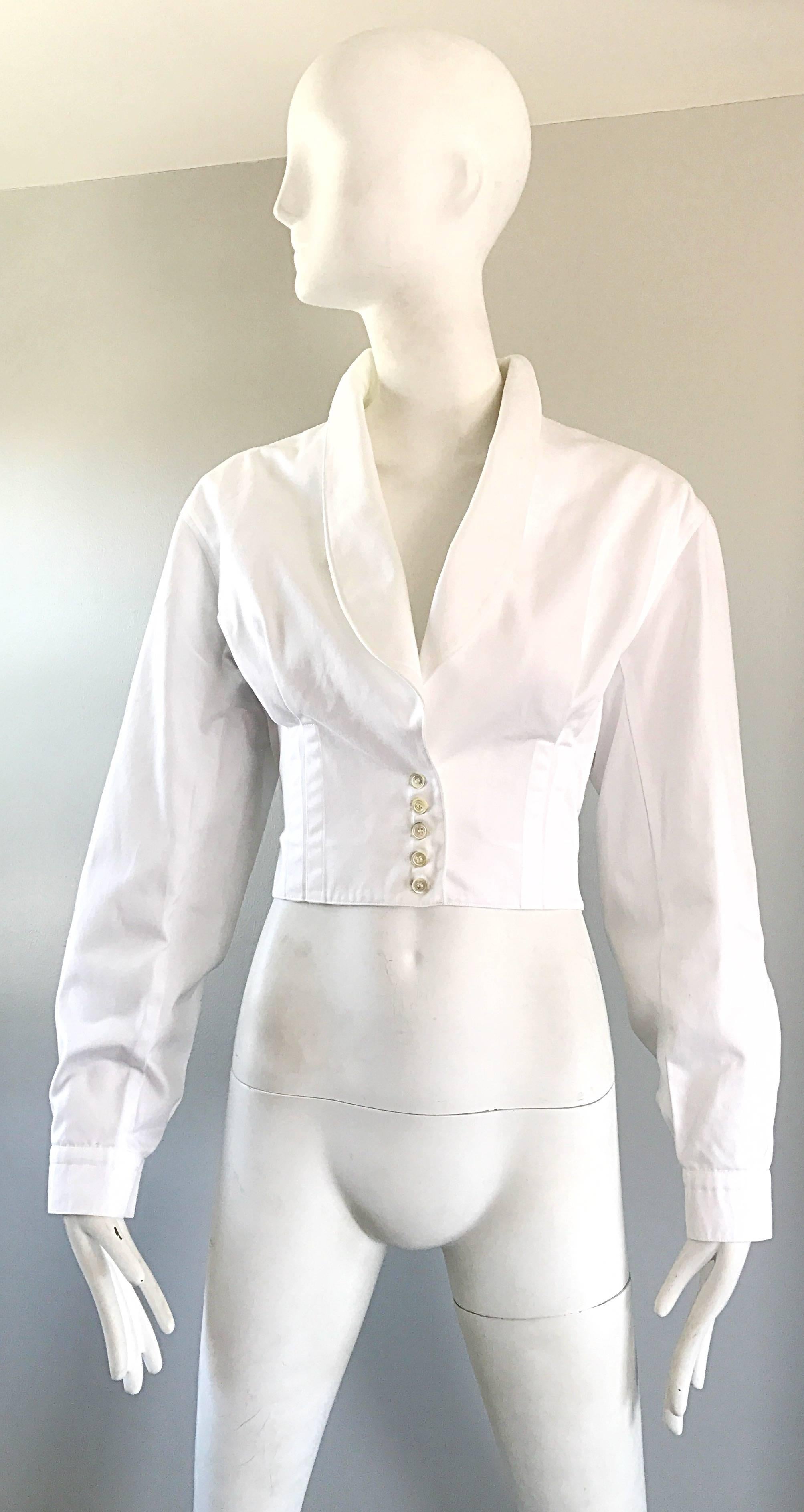 Exceptional vintage AZZEDINE ALAIA white cotton tailored cropped jacket! Featureas signature Alaia flattering curves that provide an extra slimming effect. Five buttons up the front, and buttons at each sleeve cuff. Chic shawl collar. Can easily be