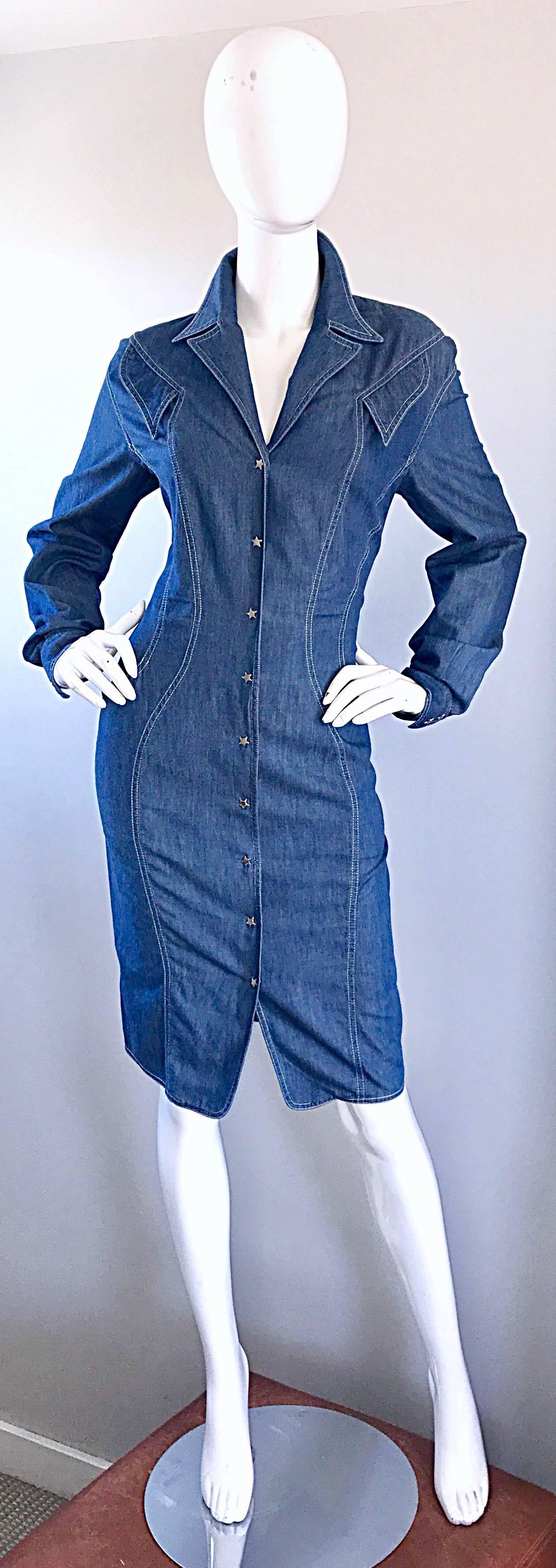 Incredible 1980s THIERRY MUGLER denim blue jean long sleeve dress! Features signature slimming stitching that is beyond flattering! Snaps shut up the front with silver star covers, and at each sleeve cuff. Angular mock pockets above each breast.