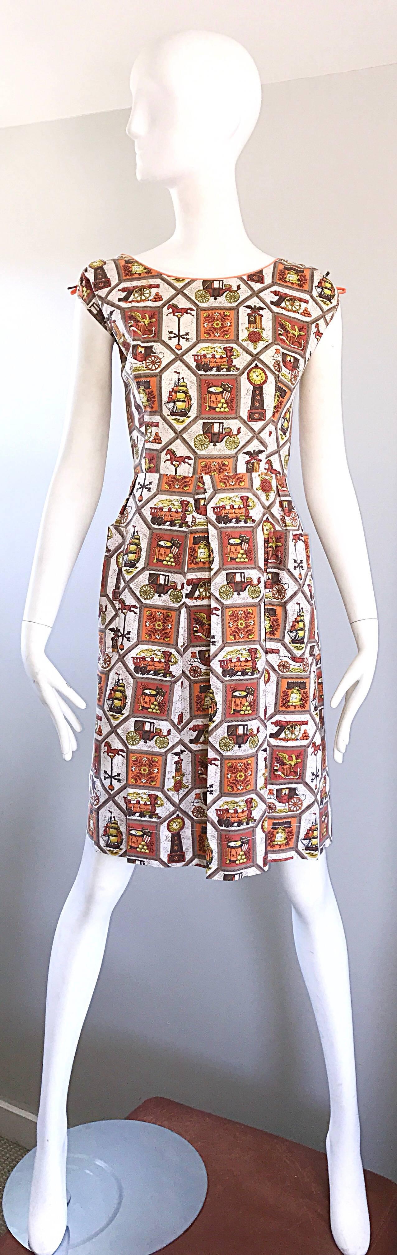Chic and rare larger plus size 1950s novelty cotton dress! Features whimsical prints of trains, toy horses, drums, clocks, flowers, ships, cannons, crests, etc. Vibrant colors of orange, brown, yellow, gold, brown and burnt orange throughout. Bright