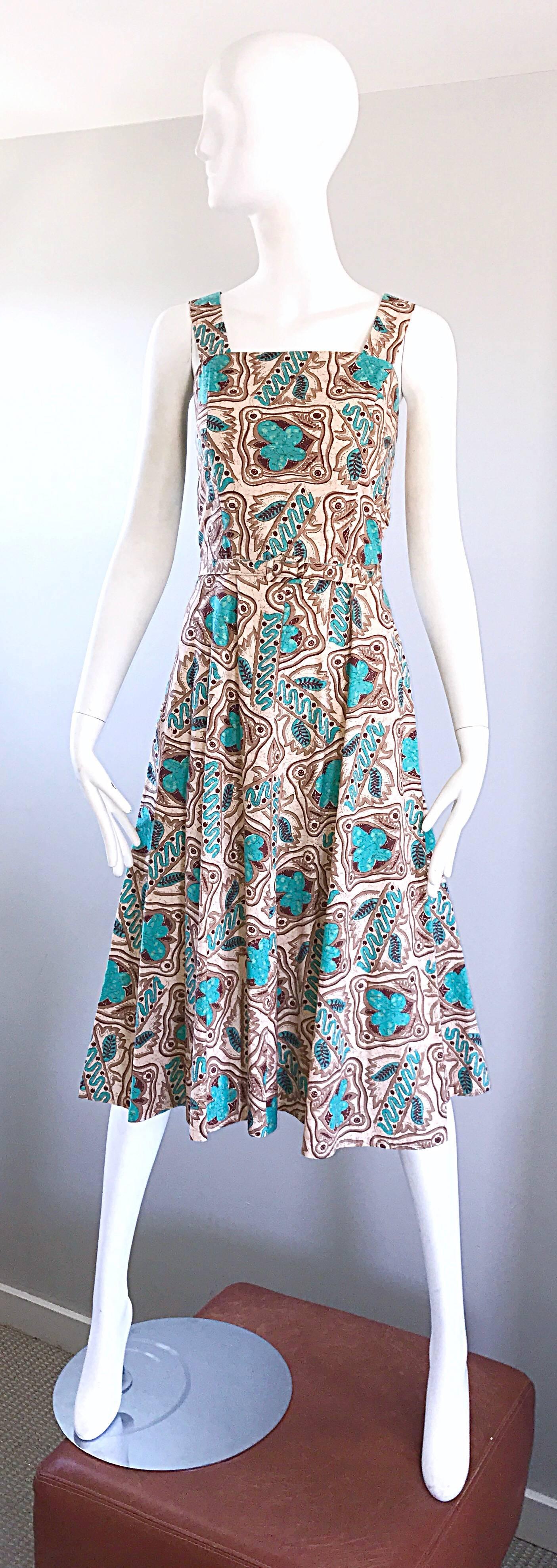 Wonderfully chic vintage 1950s turquoise teal blue, brown, tan and ivory batik print belted cotton Fit n' flare sleeveless dress! Fitted bodice, with a flattering and forgiving full skirt that could easily accommodate a crinoline underneath.