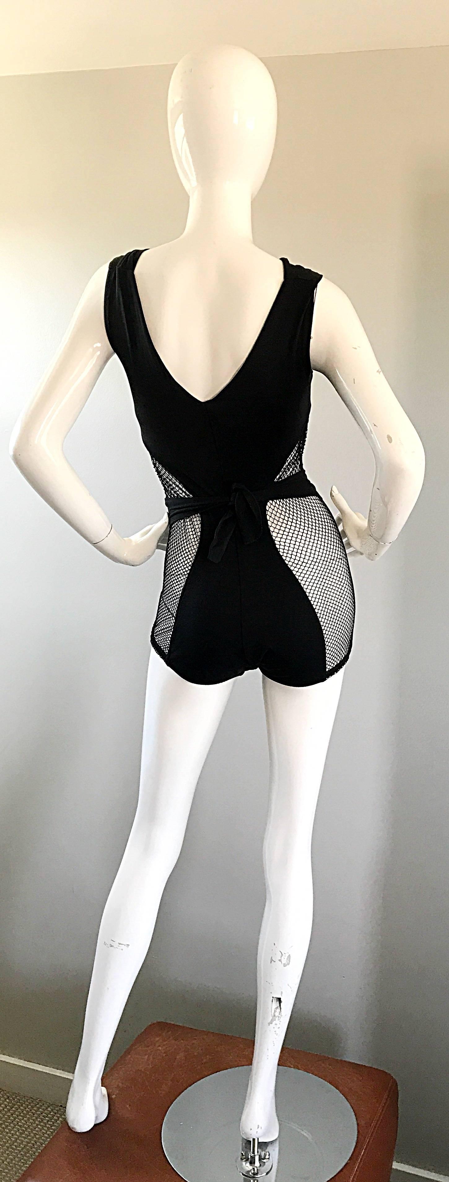 Rare early 1960s COLE OF CALIFORNIA black cut-out swimsuit or bodysuit! Features comfortable stretch jersey material. Ties in the back to accomodate fit. Cut-out at sides with a sturdy net reveals just the right amount of skin. Super slimming figure