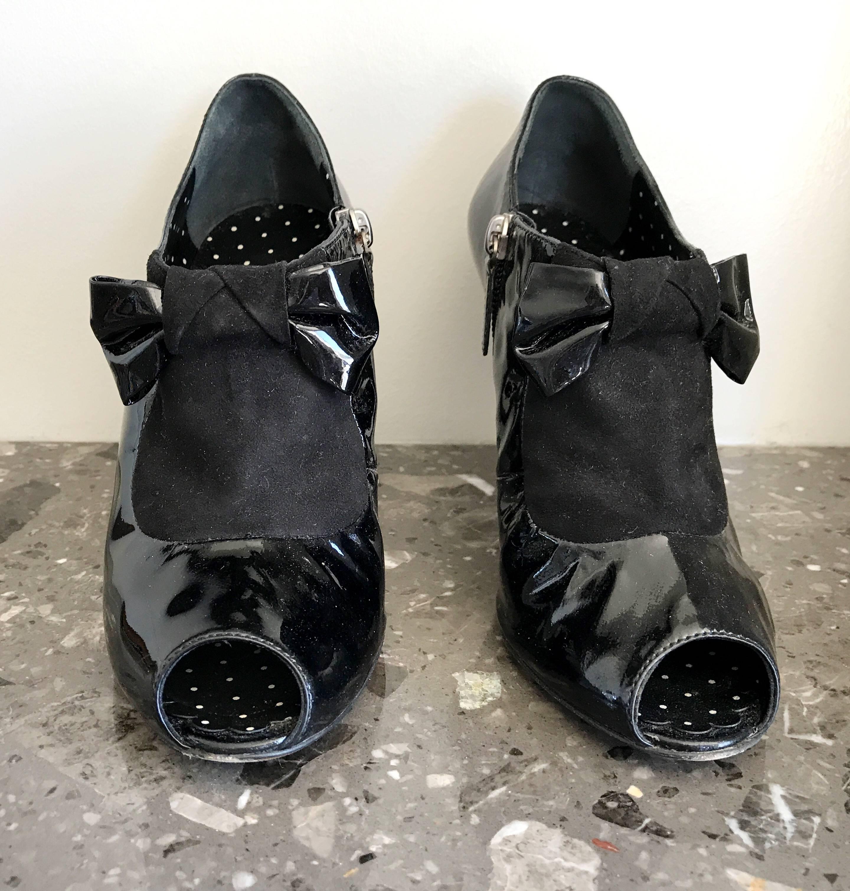 Awesome 90s black patent leather MOSCHINO 'Cheap & Chic' peeptoe tuxedo ankle boots! Features black suede above the toe, with a chic patent leather bow. Zipper up the inner ankle. Black and white mini polka dot lining. Can easily be dressed up or