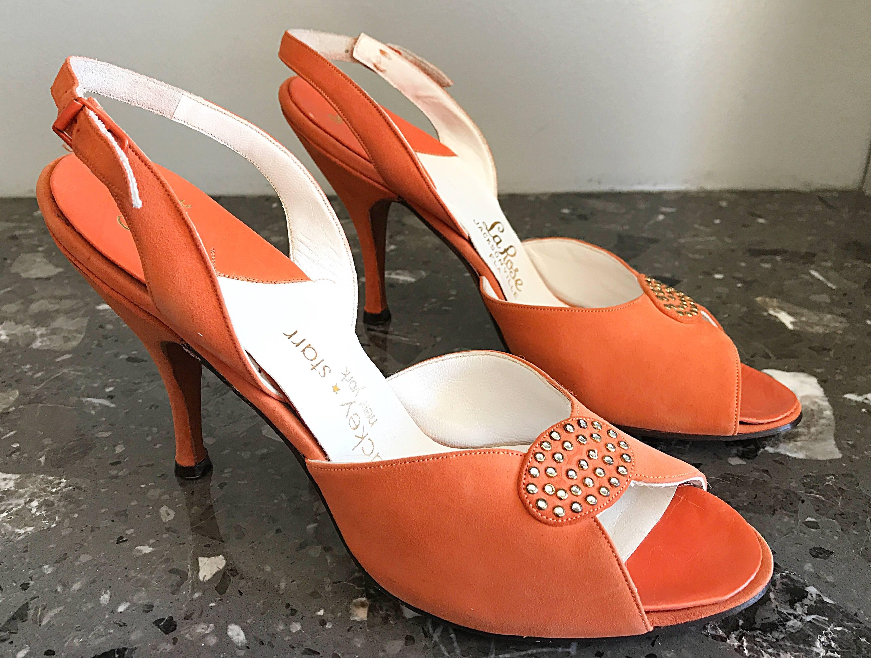 Brand new, never worn 50s vintage MACKEY STARR sorbet orange peep toe slingback high heel shoes! Features rhinestones at the toe. Adjustable sling back strap. Leather sole. Great with shorts, jeans, a skirt or a dress. 
In great unworn condition.