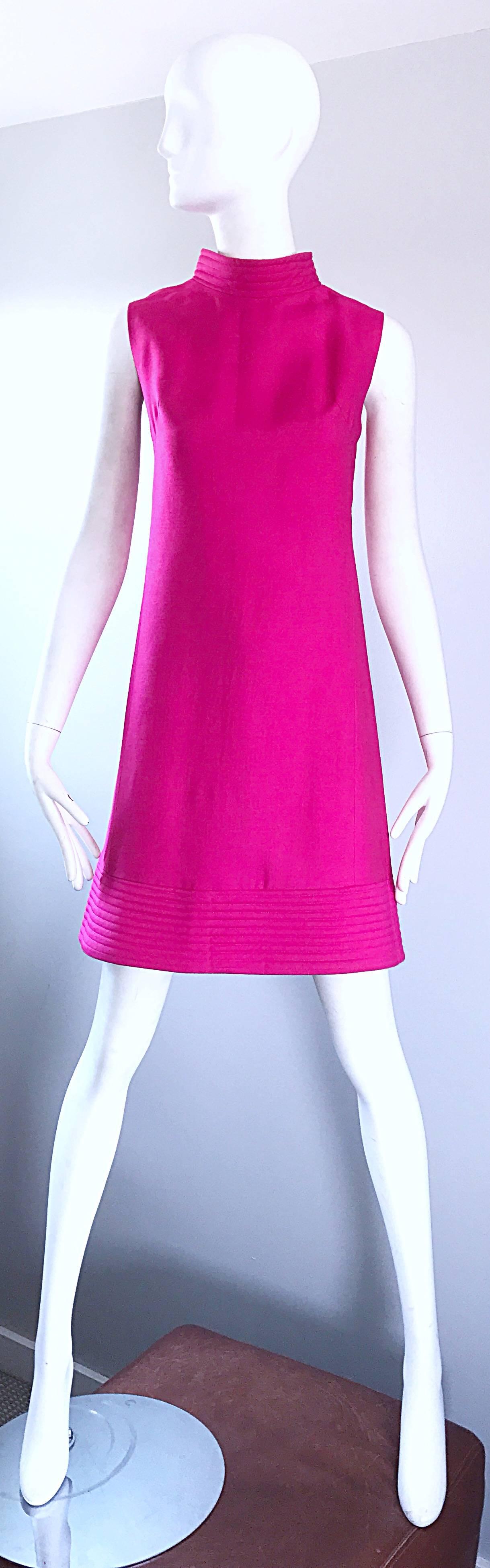 Chic 60s hot pink sleeveless silk shift dress! Features an embroidered high neck that matches the hem. Flattering tailored bodice, with a slight A-Line skirt. Full metal; zipper up the back with hook-and-eye closure. Great for any day or evening