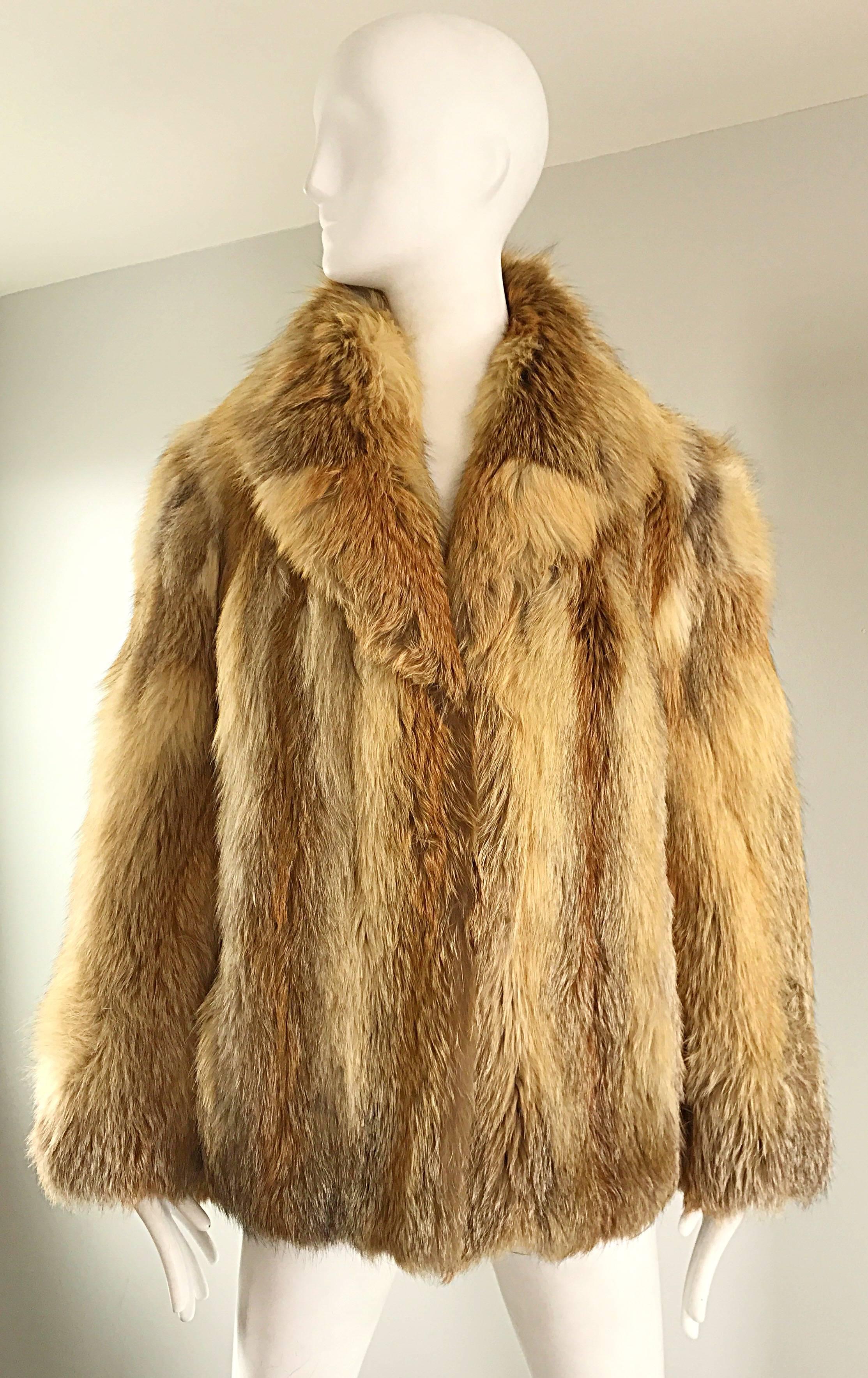 Gorgeous 1950s red fox fur jacket! Stored in a fur storage facility, and in excellent condition. Features the softest fox fur, with a beige silk lining. Two fur hook-and-eye closures up the front. Collar can be worn flipped up for extra warmth, or