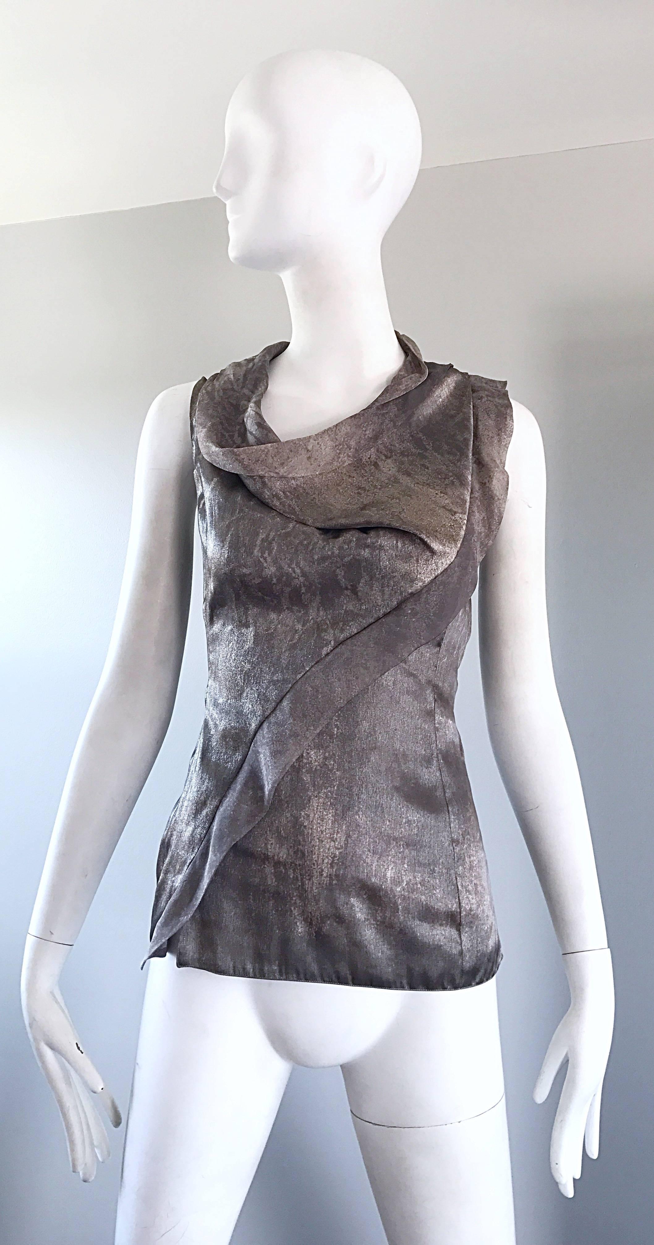 Beautiful vintage GIORGIO ARMANI 90s silver and gunmetal Avant Garde sleeveless shirt! Features luxurious silk, with an excellent draped neckline, and asymmetrical ruffle along the front bodice that drapes over the left shoulder. Hidden zipper up