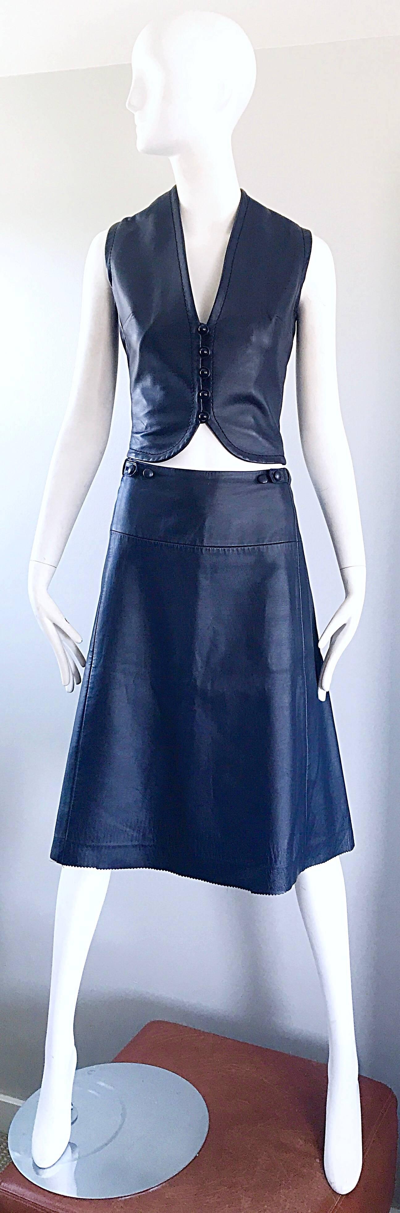 Rare 60s vintage JEAN PATOU, by KARL LAGERFELD navy blue leather crop vest and A-Line skirt! Luxurious soft leather that appears to be unworn. Vest buttons up the front. Skirt features a zipper in the back with hook-and-eye closure. Skirt also