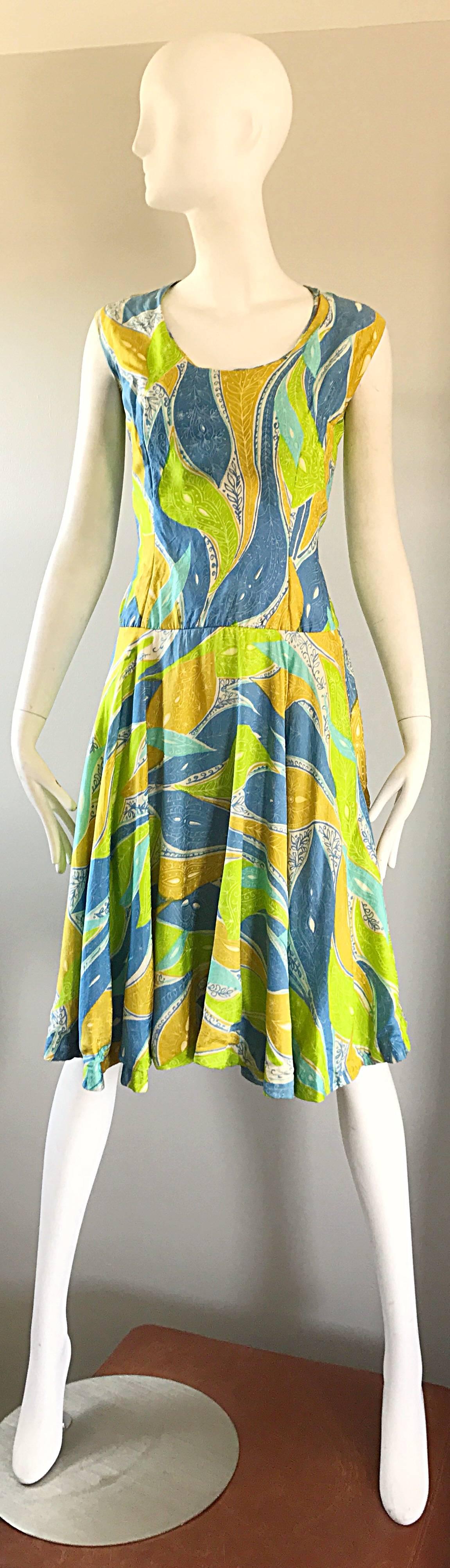 Chic 60s vintage FERN VIOLETTE blue, lime green and white abstract paisley silk dress! Features luxurious silk, with great bold prints. FItted bodice, with a flattering and forgiving full skirt. Full metal zipper up the back with hook-and-eye