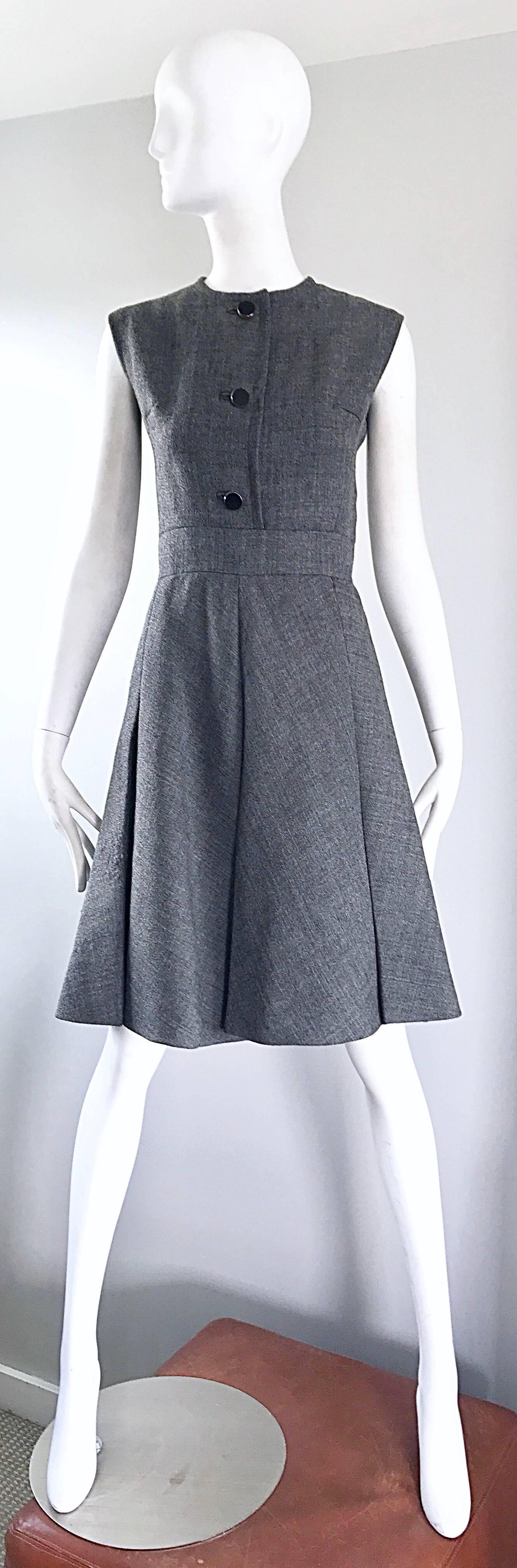 Stunning 1960s NINA RICCI HAUTE COUTURE gray wool A-Line dress and matching belted jacket suit! Jacket features the original black patent leather belt, and matching buttons. Two pockets at each side of the waist. Dress features a fitted bodice, and
