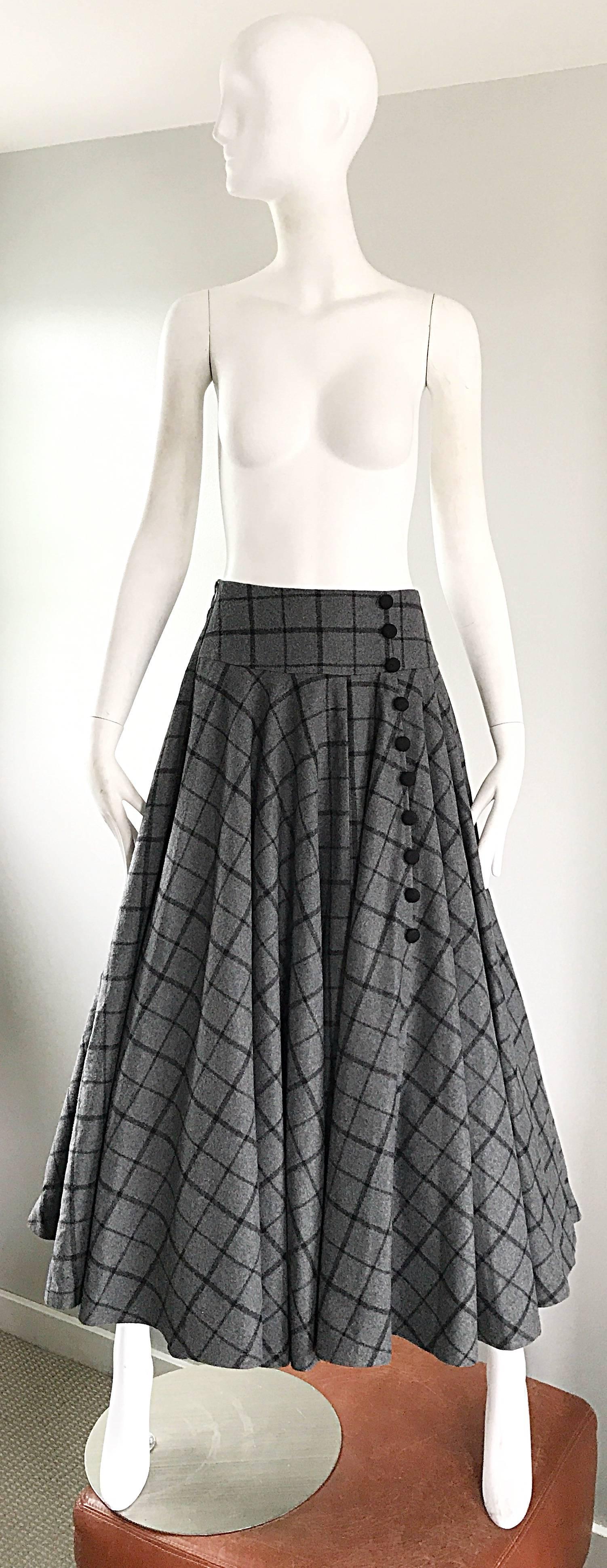 Unbelievable chic 1950s gray and black windowpane checkered wool full maxi skirt! Features a soft heavy virgin wool. Hidden zipper up the side. Waistband features elastic on the back, so will fit a variety of sizes. Ten black mock buttons up the