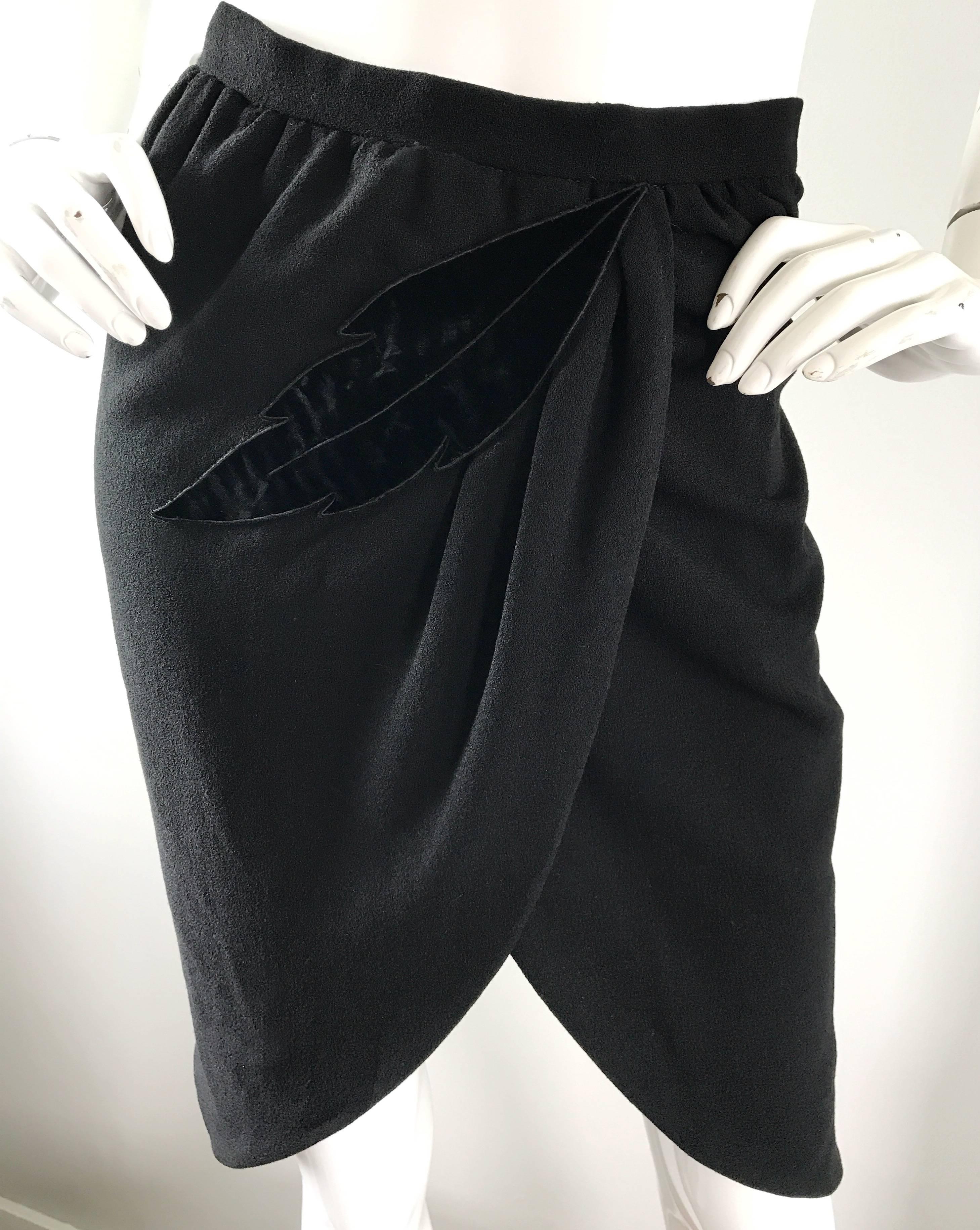 Not just your basic black skirt! This 1990s / 90s black virgin wool vintage VALENTINO high waisted pencil skirt features a black velvet leaf motif appliqué on the front. Flattering draped detail, with a tulip hem. Hidden metal zipper up the side