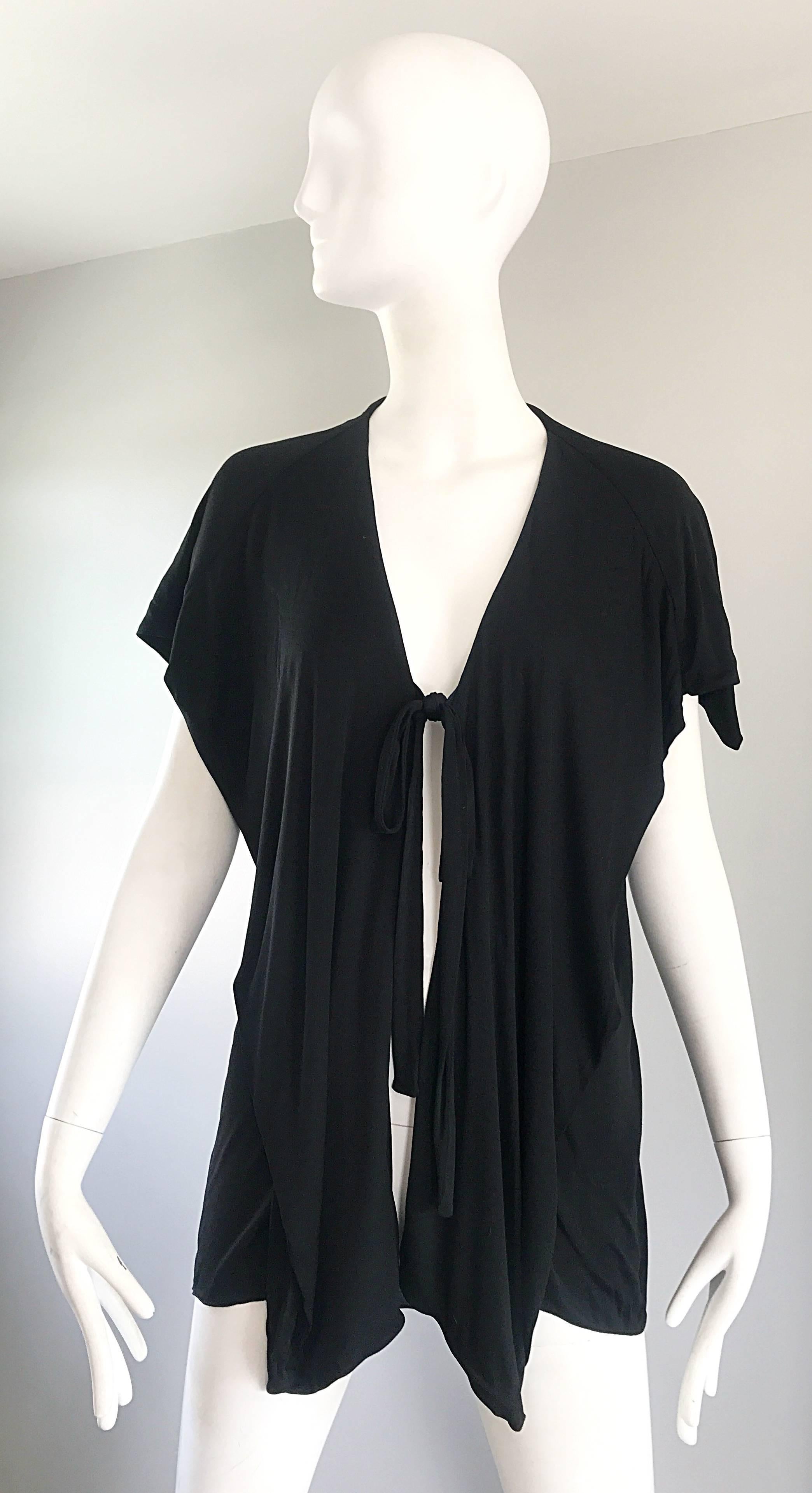 Rare early 70s HOLLY'S HARP early label black silk jersey short dolman sleeve wrap cardigan! Features Harp's signature drapes and gathers throughout. Ties shut at center bust, though could also be left open. The perfect chic everyday 'throw on' that