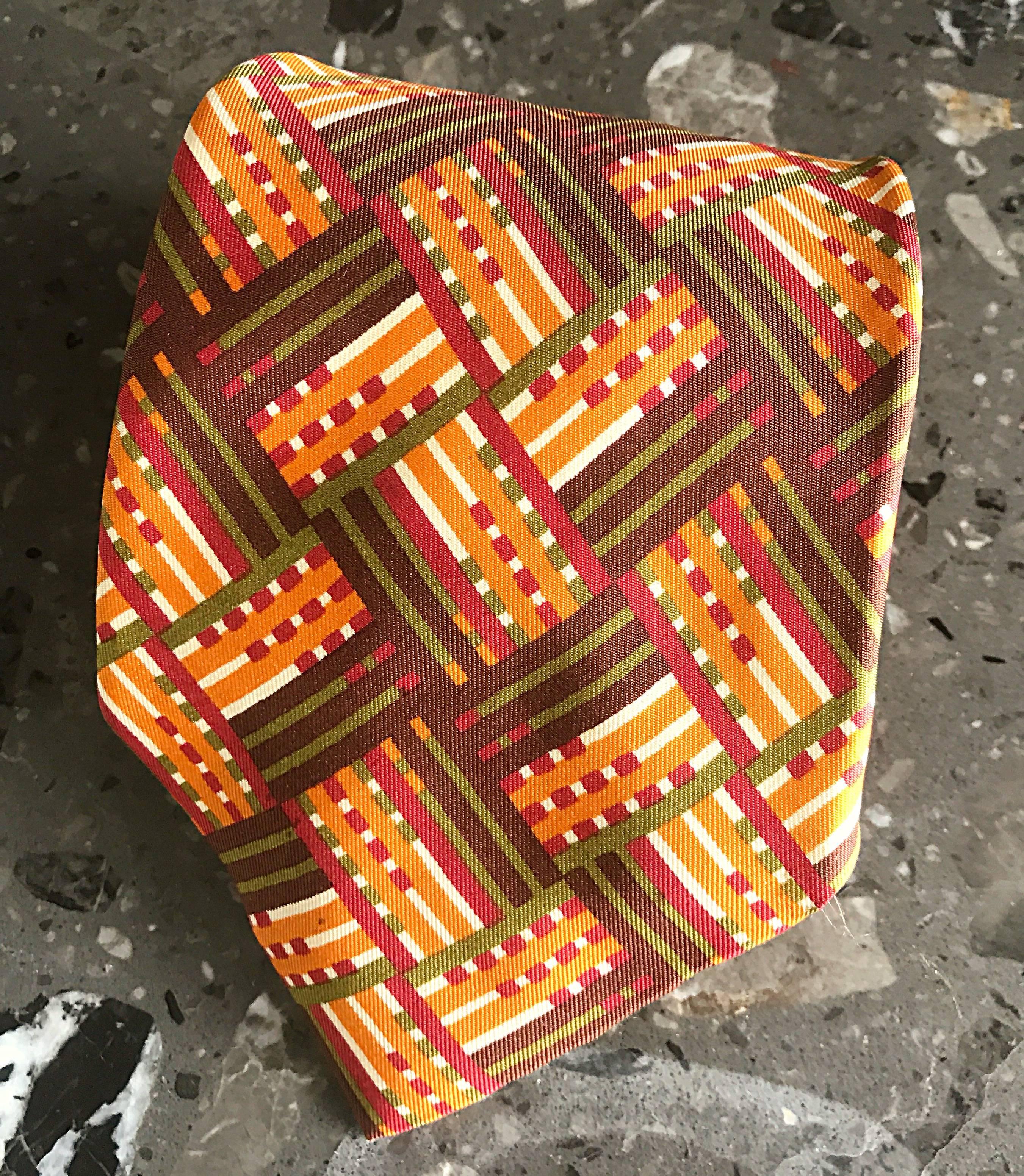 Rare 70s HERMES men's silk necktie! Features abstract plaid print in warm autumnal tones of brown, burgundy and orange. Great with a suit, blazer or with jeans. Also, makes the perfect gift! In great unworn condition. 
Made in France 


