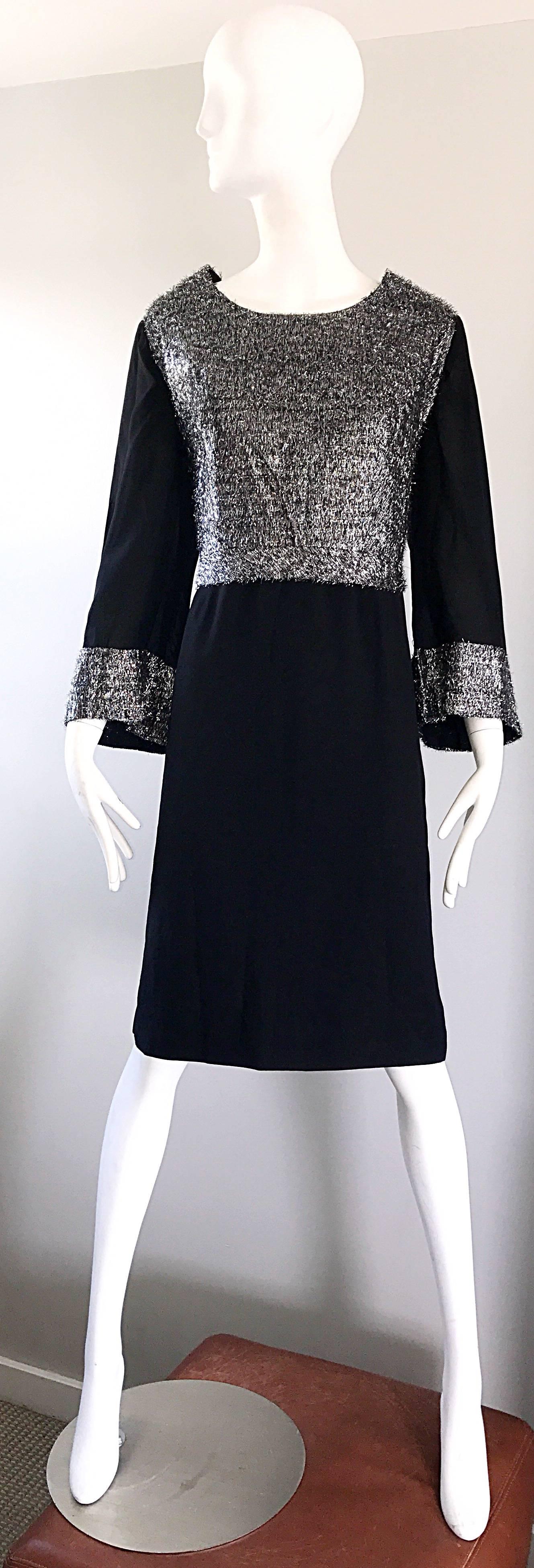 Chic 1960s black and silver crepe rayon plus size dress! Features a tailored silver metallic lurex bodice, with a flattering and forgiving shift shape. Stylish wide bell sleeves. Full metal zipper up the back with hook-and-eye closure. The perfect