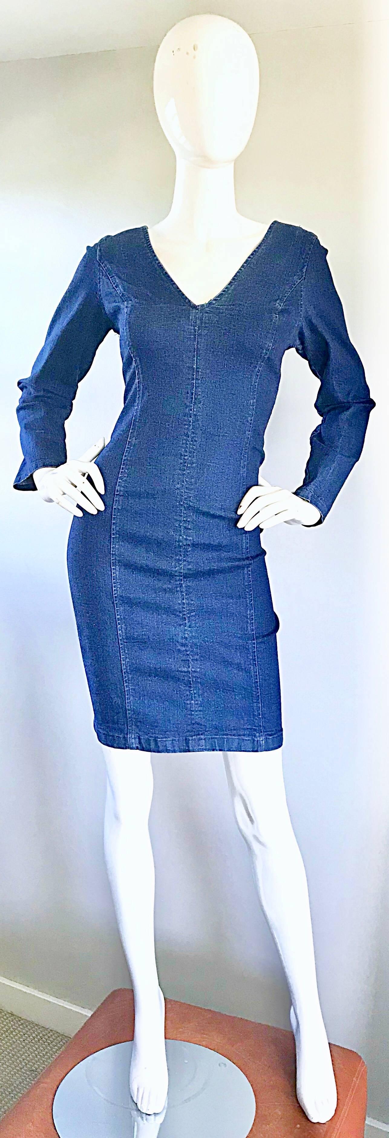 Sexy 1990s dark wash denim blue jean long sleeve bodcon dress! Features a form fitting cotton (98%) and lycra (2%) denim that offers some stretch. Hugs the body in all the right places. Full metal zipper up the back. Great belted or alone with