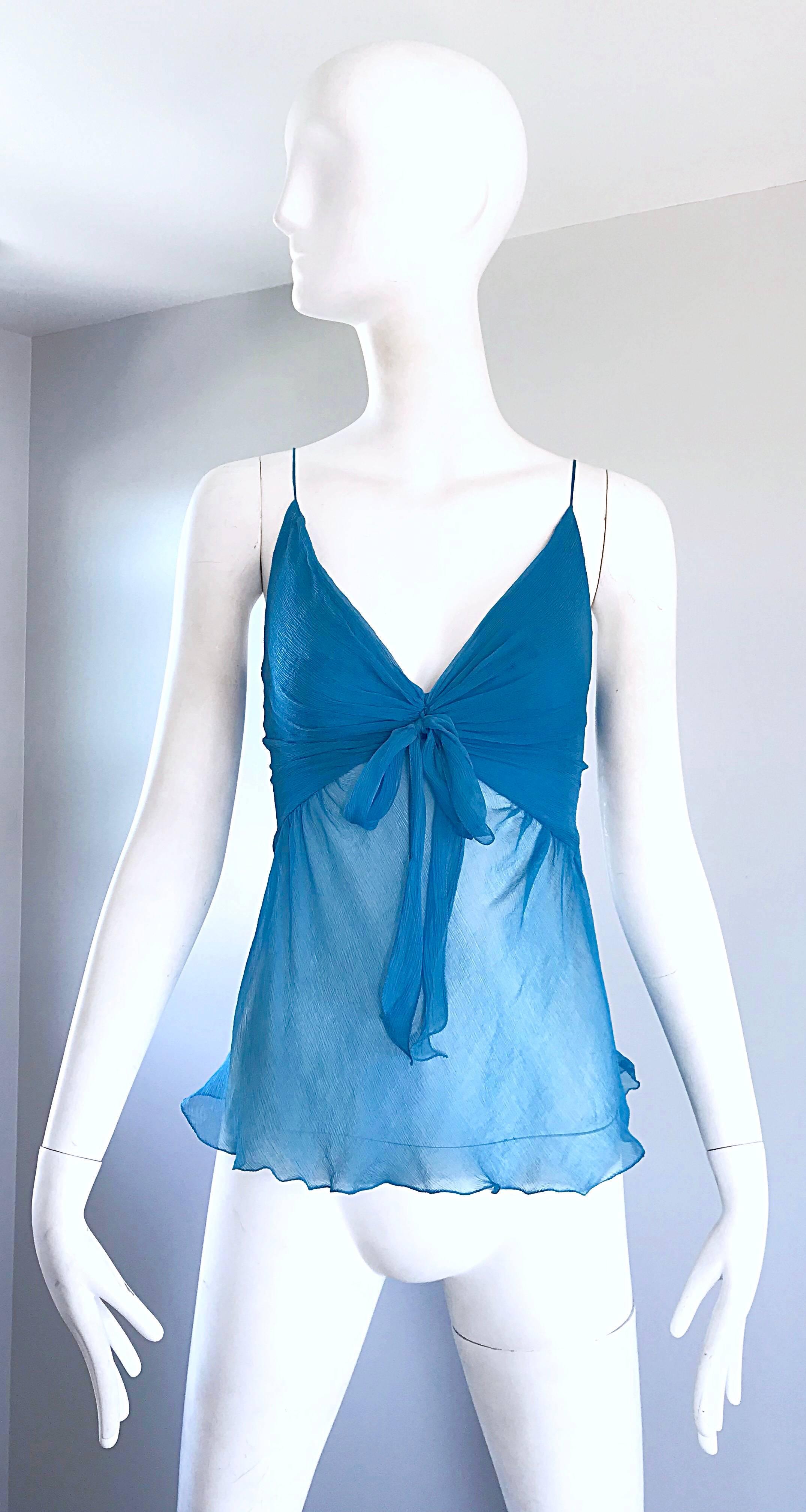 Beautiful 1990s ALESSANDRO DELL'ACQUA turquoise blue silk chiffon semi sheer sleeveless empire waist blouse! This piece if from the fashion designer's first line, which was created in 1996. Features a tie in the front. Fitted bust with a free