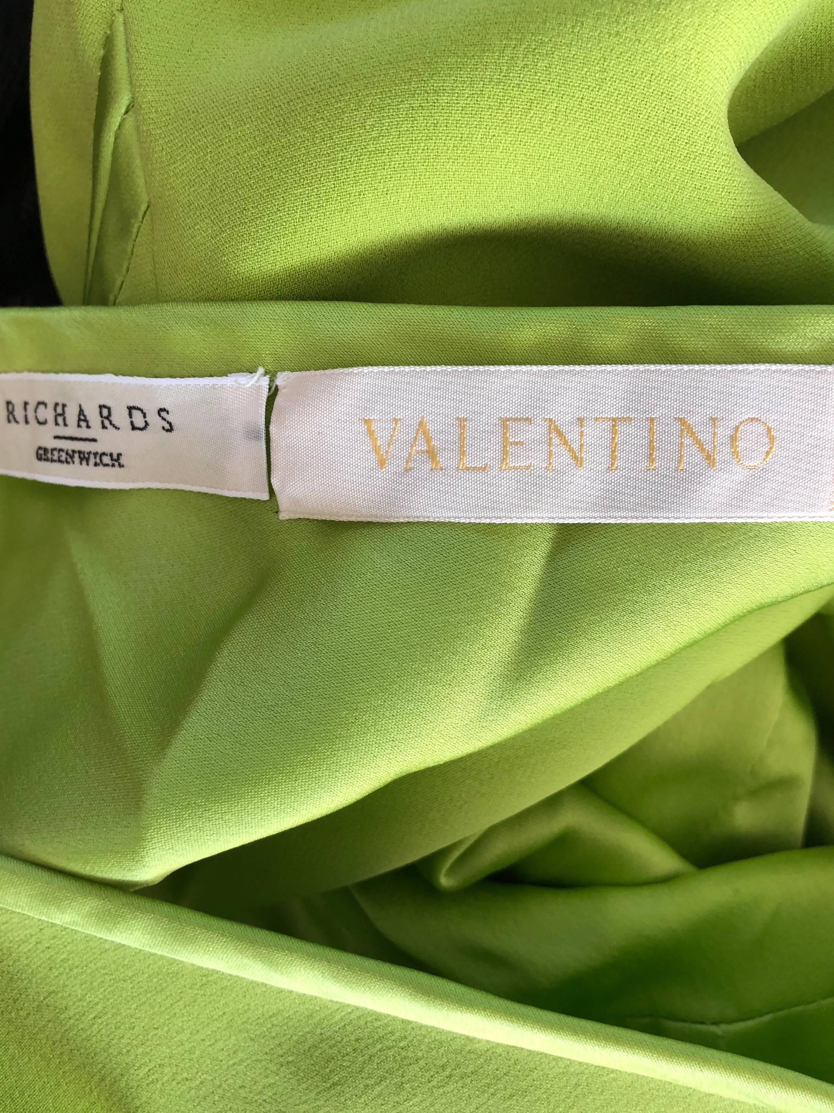 Sexy never worn late 1990s lime neon green silk VALENTINO cut-out dress! Features a flattering bodcon silhouette that stretches to fit. Per-tied bows up the bodice tiered with cut-outs to reveal just the right amount of skin. Wonderfully made, with