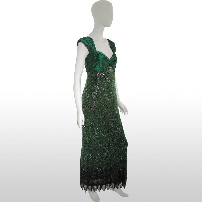 This gorgeous late 1980’s / early 1990’s gown from Bellville Sassoon - Lorcan Mullany is made from luxurious pure silk in tones emerald green. The bust and wide straps are gathered to reveal an elegant sweetheart neckline. The dress drapes from the